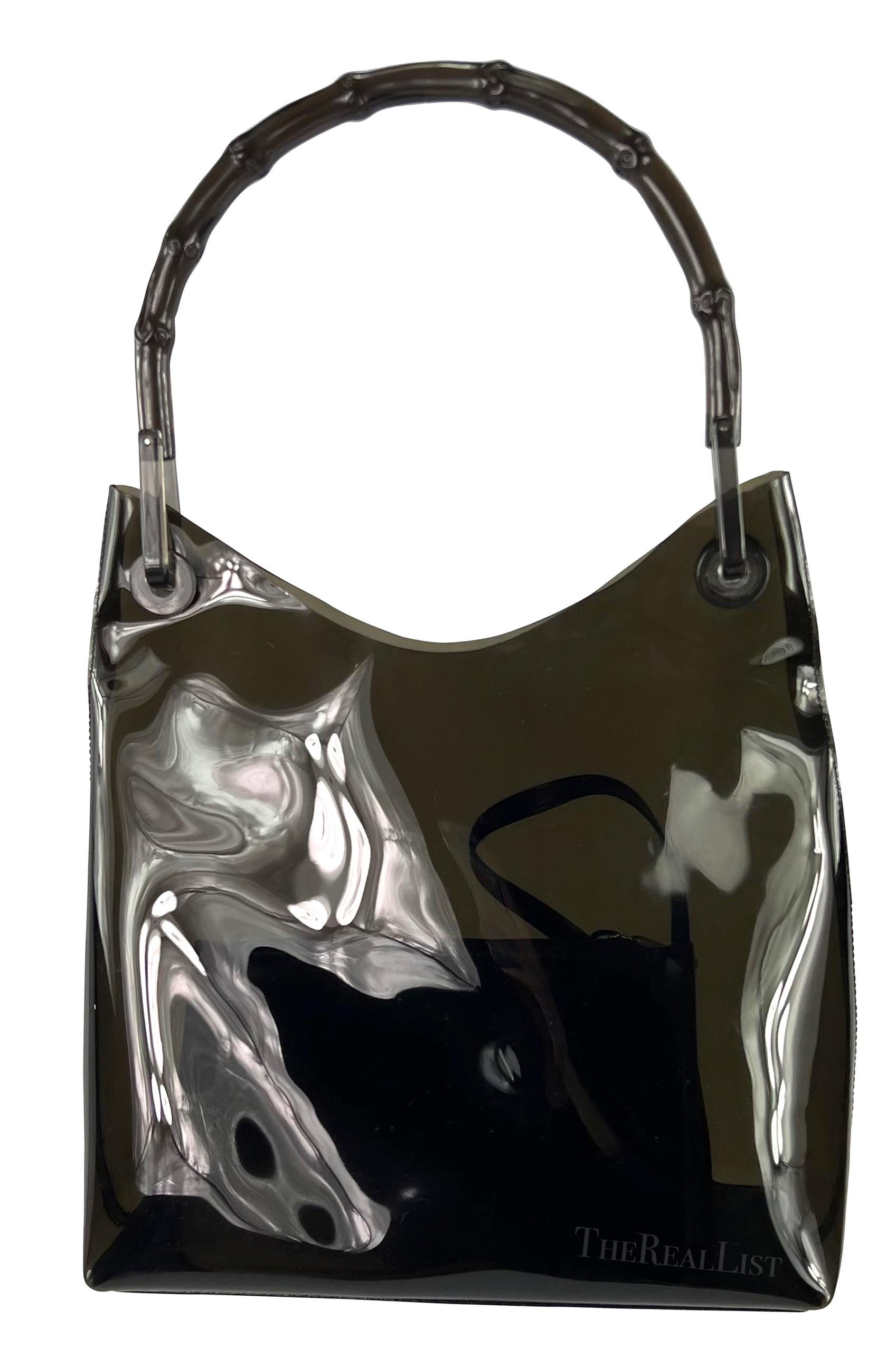 Presenting a fabulous black transparent PVC Gucci tote, designed by Tom Ford. From the late 1990s, this bag showcases a mesmerizing semi-transparent black PVC composition. The inclusion of a PVC bamboo handle not only infuses the piece with a touch