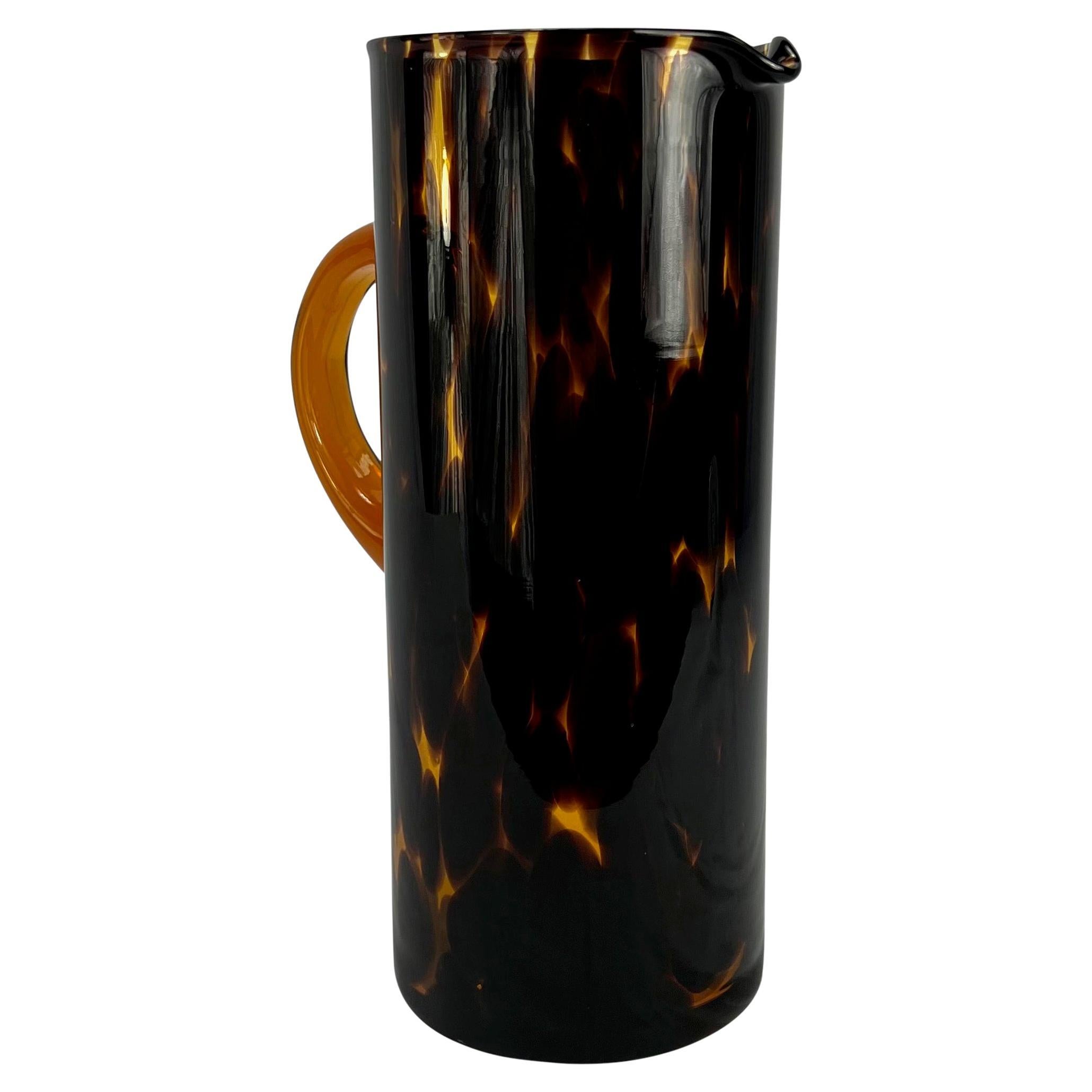 Presenting a beautiful tortoiseshell blown glass Gucci pitcher designed by Tom Ford. From the late 1990s, this vintage Gucci pitcher is the perfect addition to any serving collection. 

Approximate Measurements: 
Height: 10.5