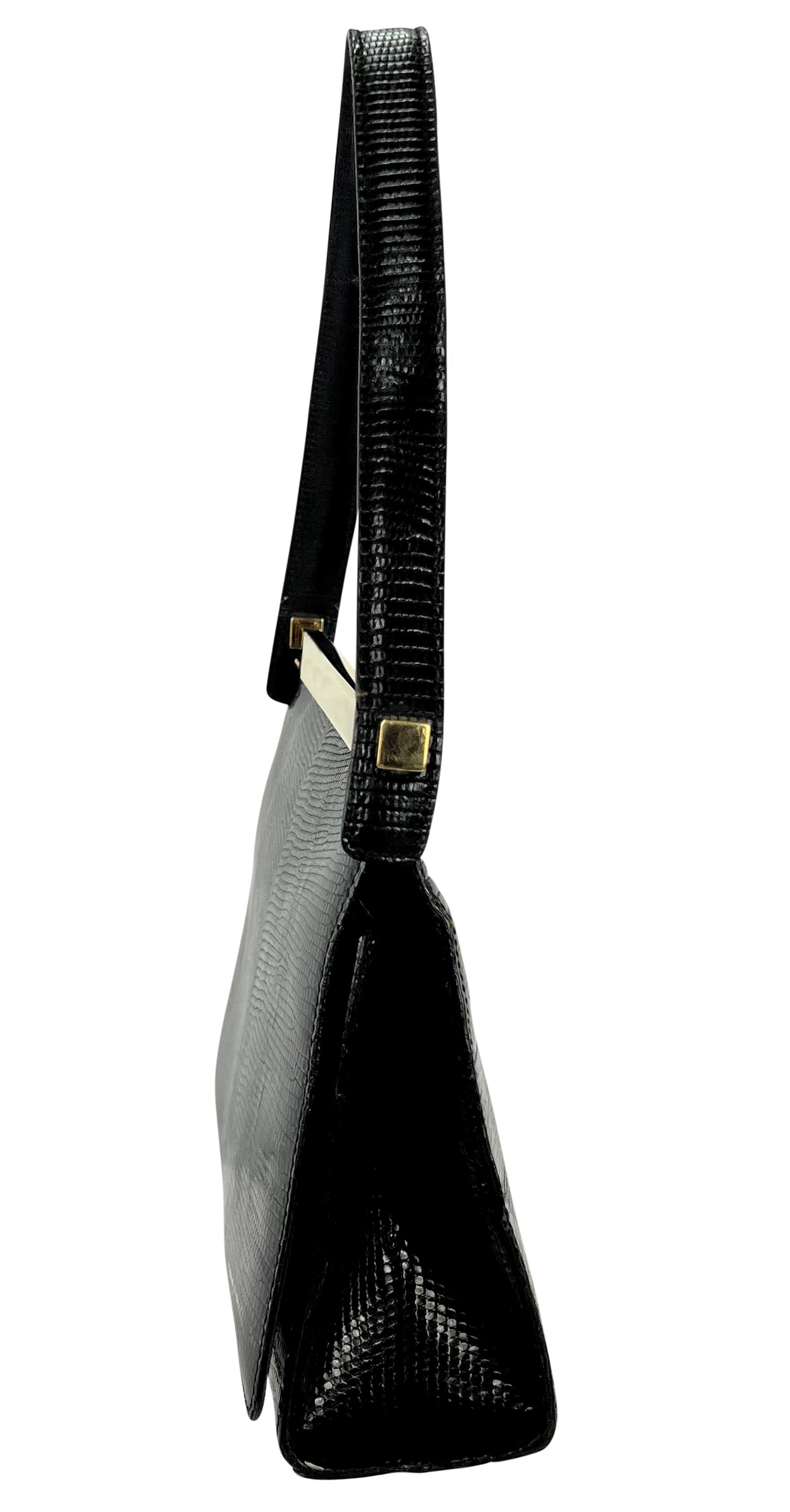 Tom Ford designed this elegant black lizard leather bag for Gucci's collection in the late 1990s. Crafted entirely from black lizard skin, this small flap-style bag is finished with a striking gold-tone metal bar accent that runs across the top.