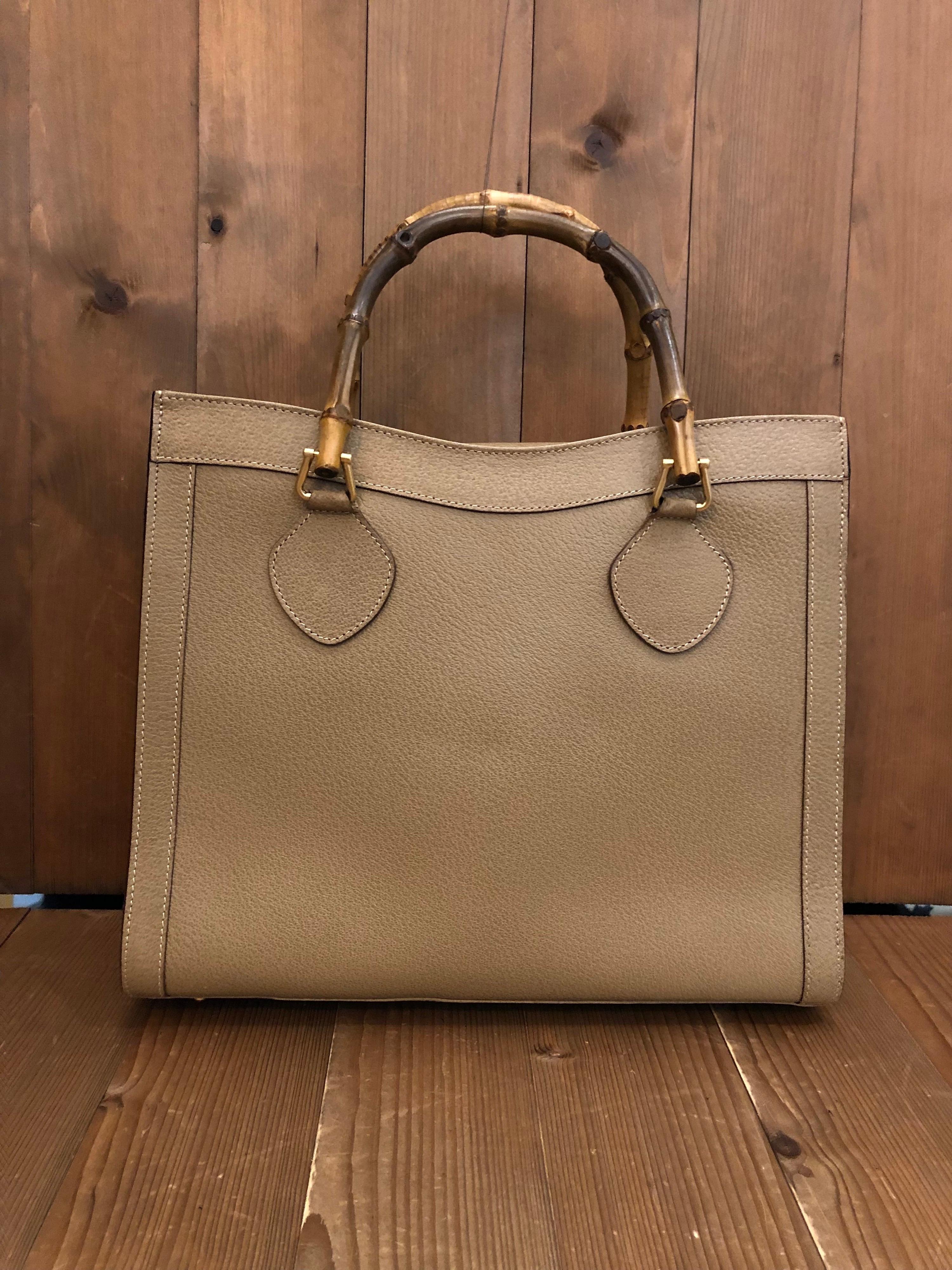 1990s Gucci bamboo tote in khaki leather. The Bamboo tote is one of Princess Diana's favorite purses. Gucci revamped this Bamboo tote in 2021 winter collection. Made in Italy. Measures 13 x 11 x 5.25 inches handle drop 5 inches. It features two main