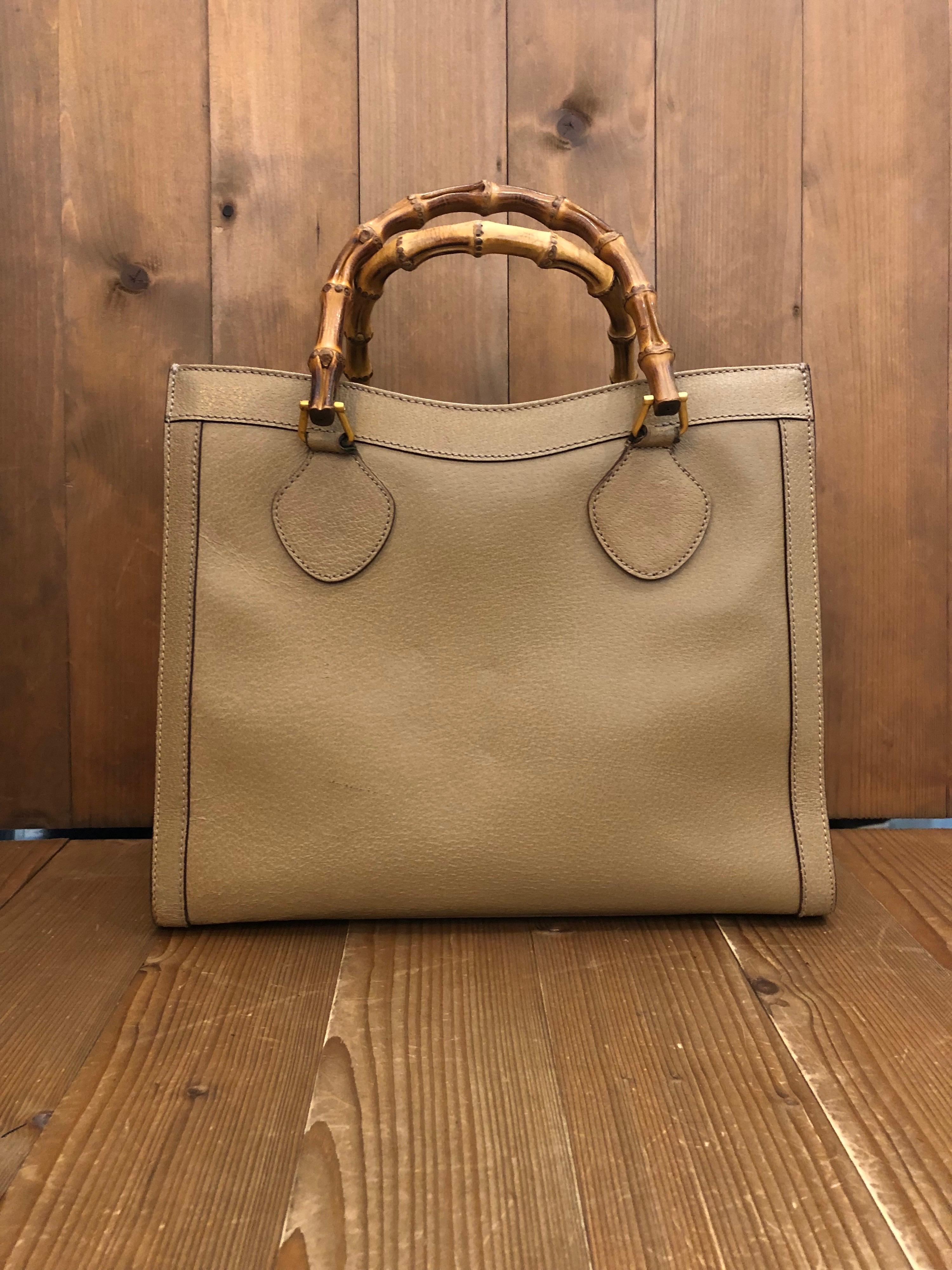 1990s Gucci bamboo tote in khaki leather. The Bamboo tote is one of Princess Diana's favorite purses. Gucci revamped this Bamboo tote in 2021 winter collection. Made in Italy. Measures 13 x 11 x 5.5 inches handle drop 5 inches. It features two main