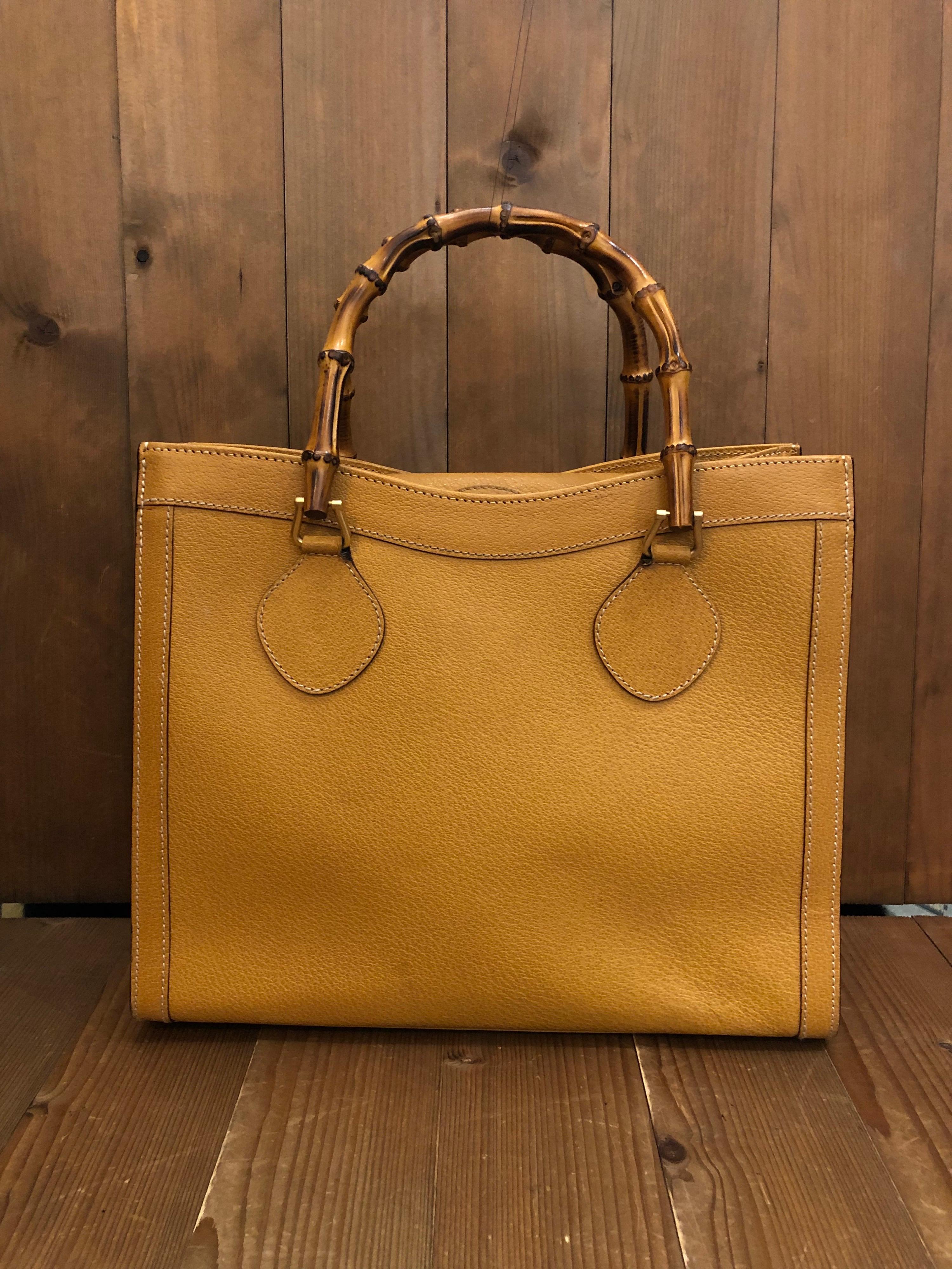 1990s Gucci bamboo tote in mustard yellow leather. The Bamboo tote is one of Princess Diana's favorite purses. Gucci revamped this Bamboo tote in 2021 winter collection. Made in Italy. Measures 13 x 11 x 5.5 inches handle drop 5 inches. It features