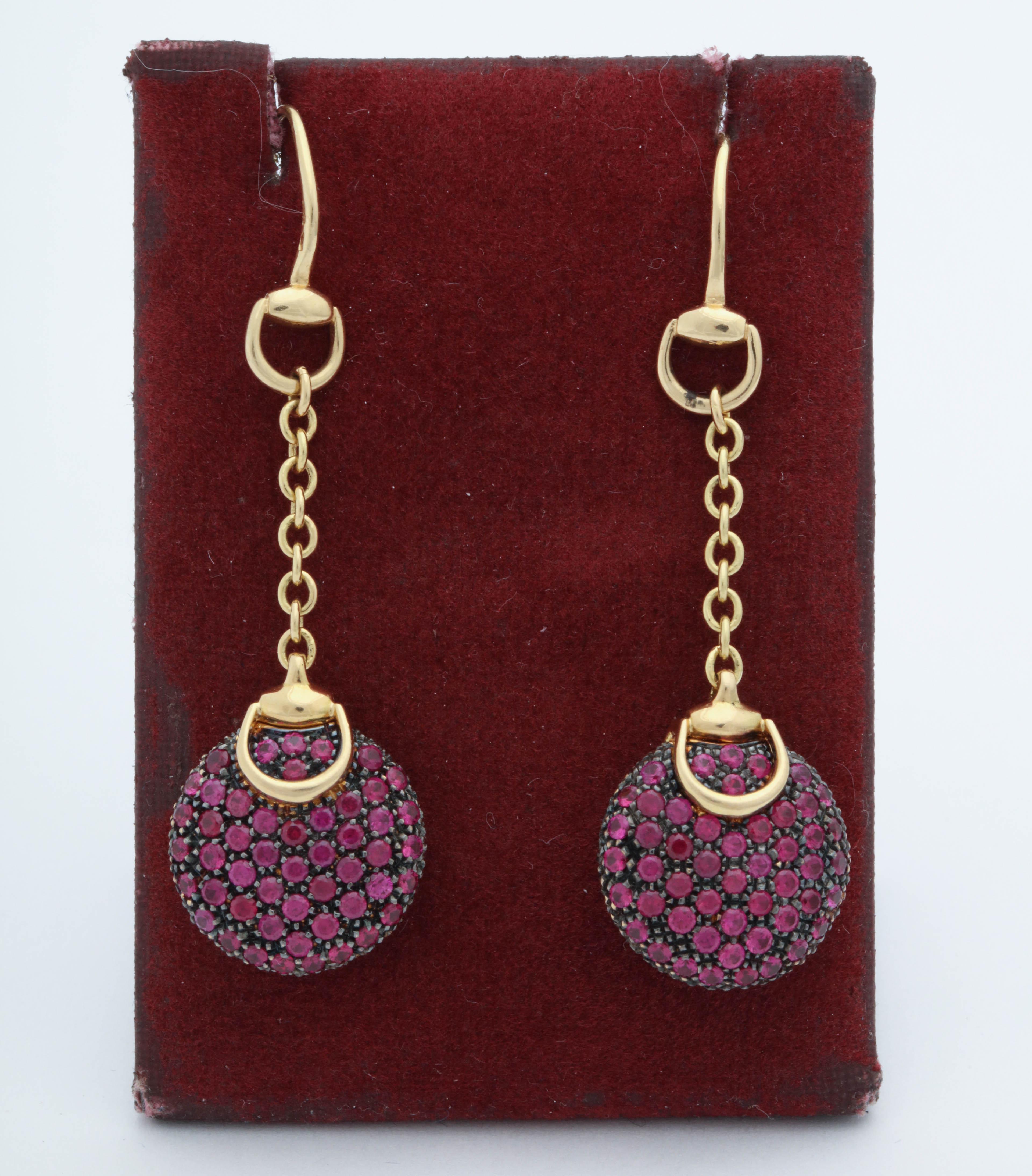 One Pair Of Ladies 18kt Yellow Gold Pendant Drop Earrings Embellished With Numerous Faceted Rubies Weighing Approximately 3 Carats Total Weight. Beautifully Designed With Gucci's Signature Gold Stirrups Craftmanship. NOTE: For Pierced Ears Only.