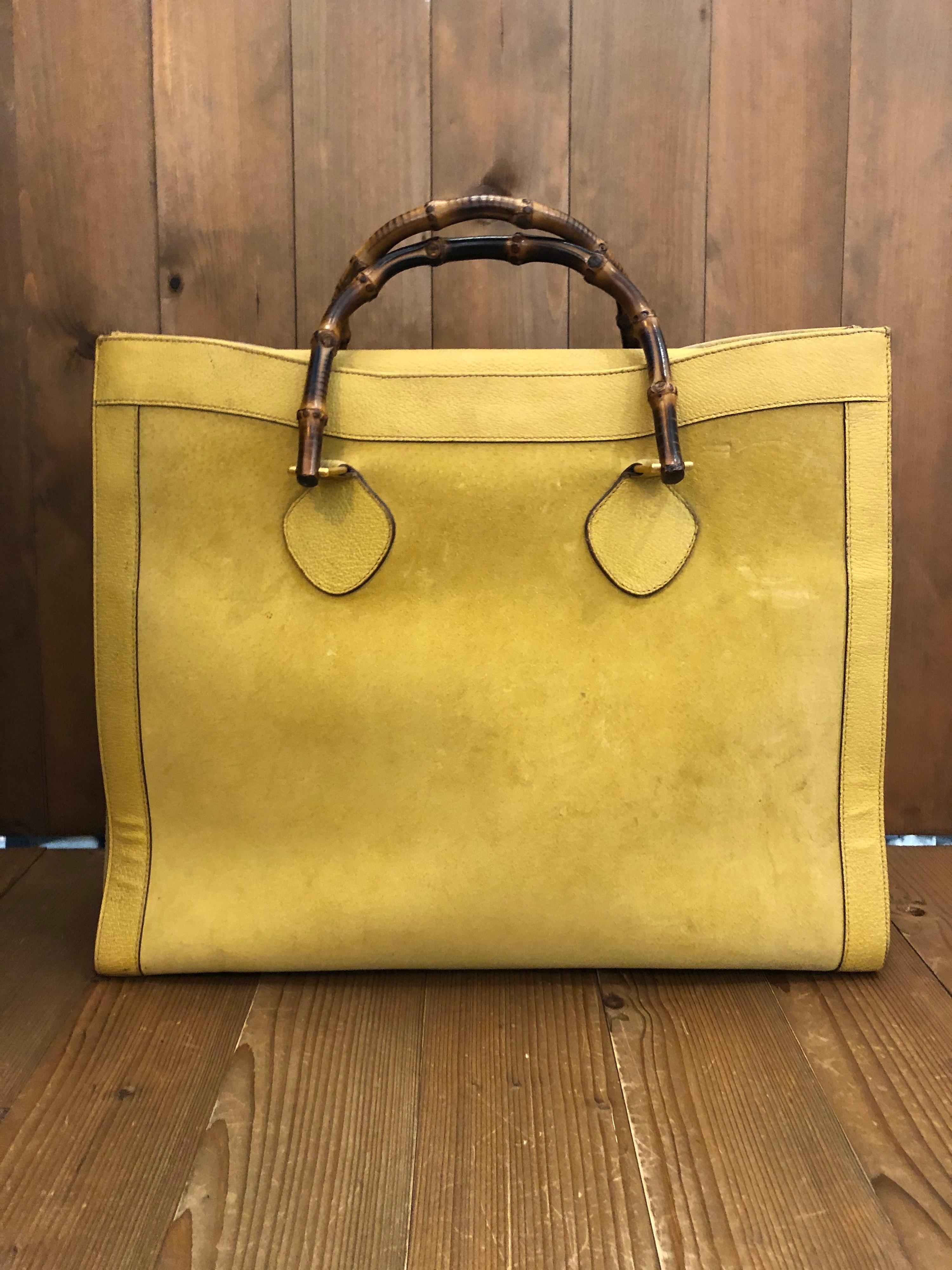 1990s Gucci bamboo tote in yellow suede and leather. The Bamboo tote is one of Princess Diana's favorite purses. Gucci revamped this Bamboo tote in 2021 winter collection. Made in Italy. Measures 16.5 x 14 x 5.25 inches handle drop 4” (large size)