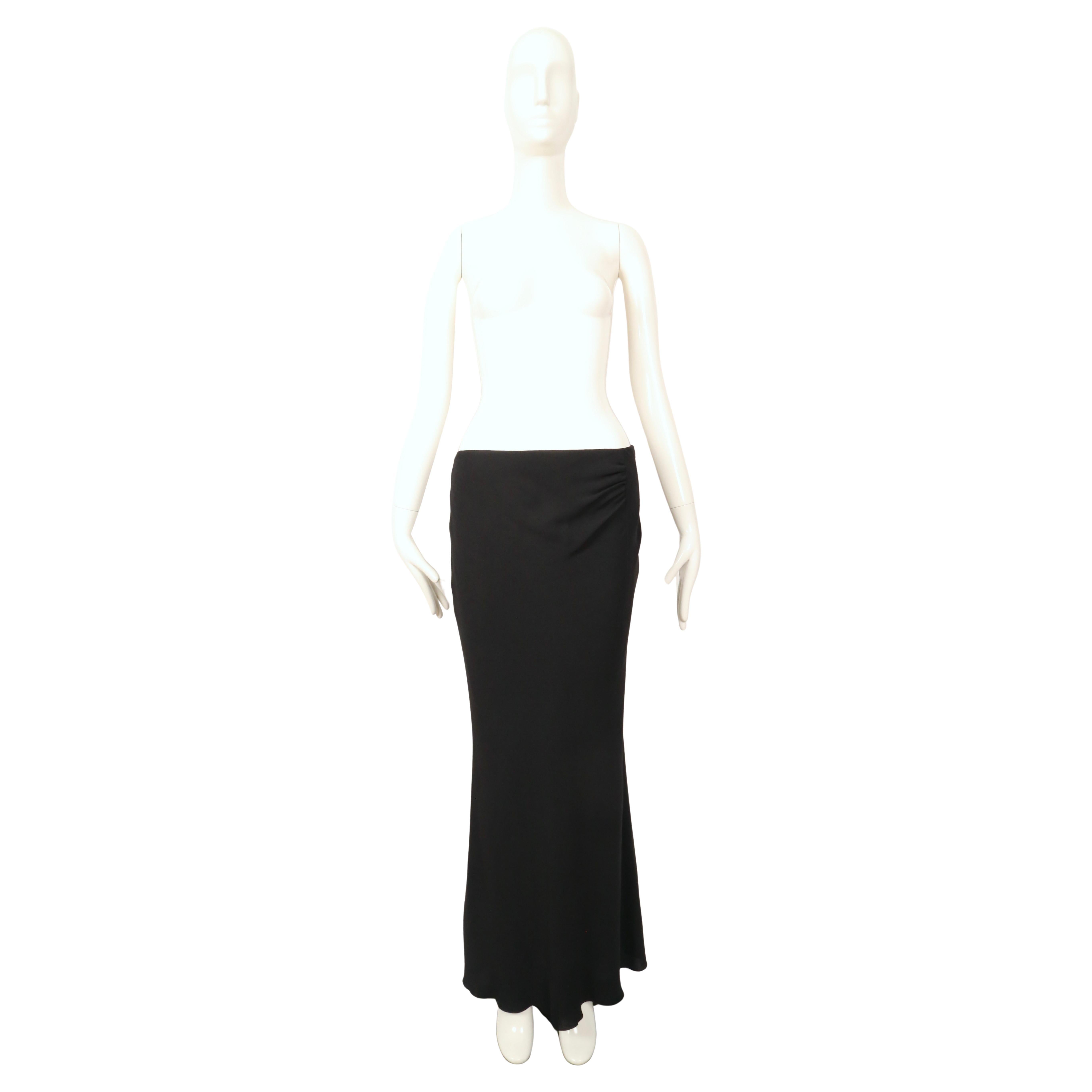 Jet black bias cut silk skirt with ruching at side from Guy Laroche dating to the early 1990's. Labeled a French size 40, however this best fits a 4 or 6. The skirt was not clipped on the size 2 mannequin. Waist measures 32