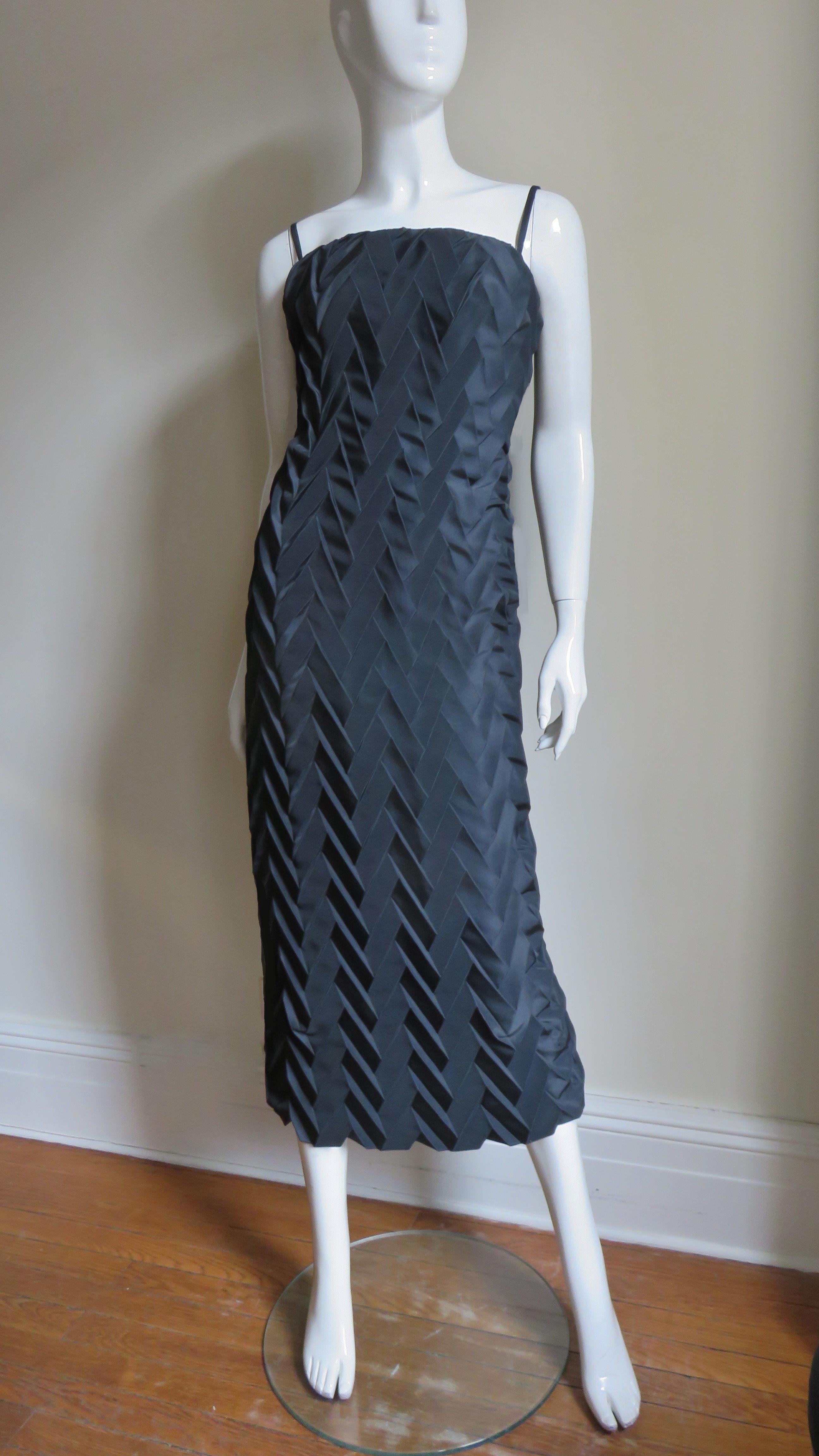 A fabulous black silk dress from Hanae Mori.  It is simply cut with spaghetti straps and an intricately  chevron pleated body.  It has an invisible side zipper and is silk lined. 
Fits sizes Small, Medium. Marked French size 42.

Bust  34-36