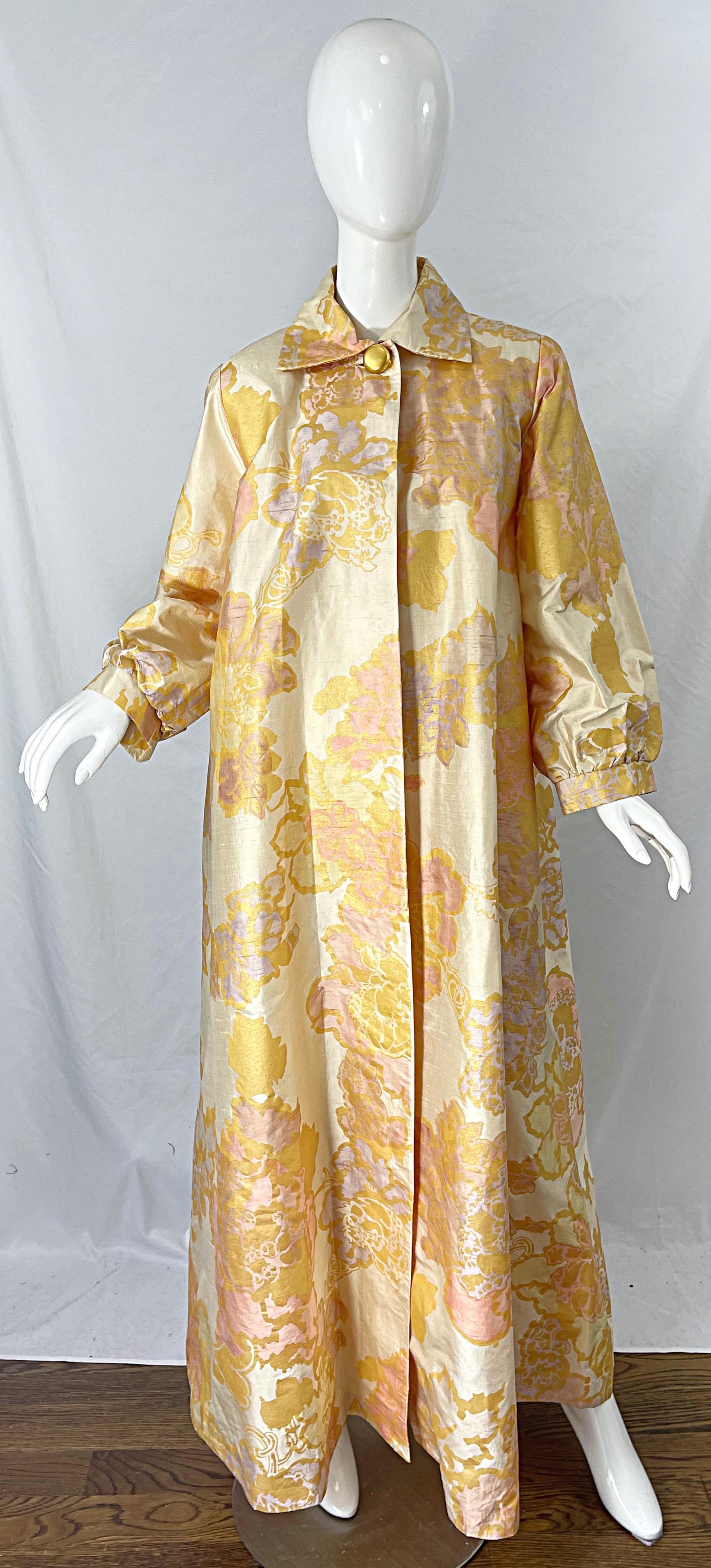 Gorgeous 90s hand painted couture quality silk taffeta pink, ivory and gold abstract print opera coat ! Features a regal floral abstract print throughout. Gold matte button at top center neck. Pockets at each side of the waist. Fully lined. Great