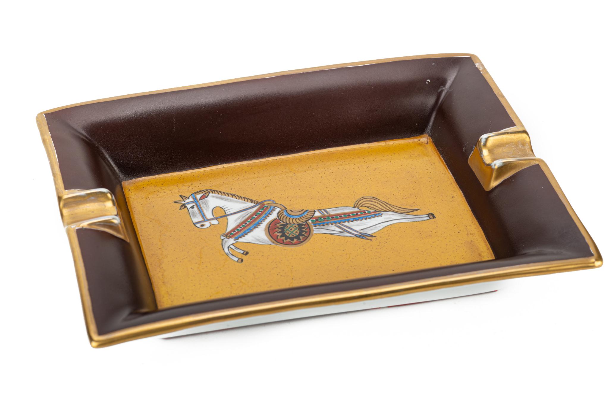 1990's Hermes excellent condition porcelain ashtray with horse design. Brown and gold color combination.