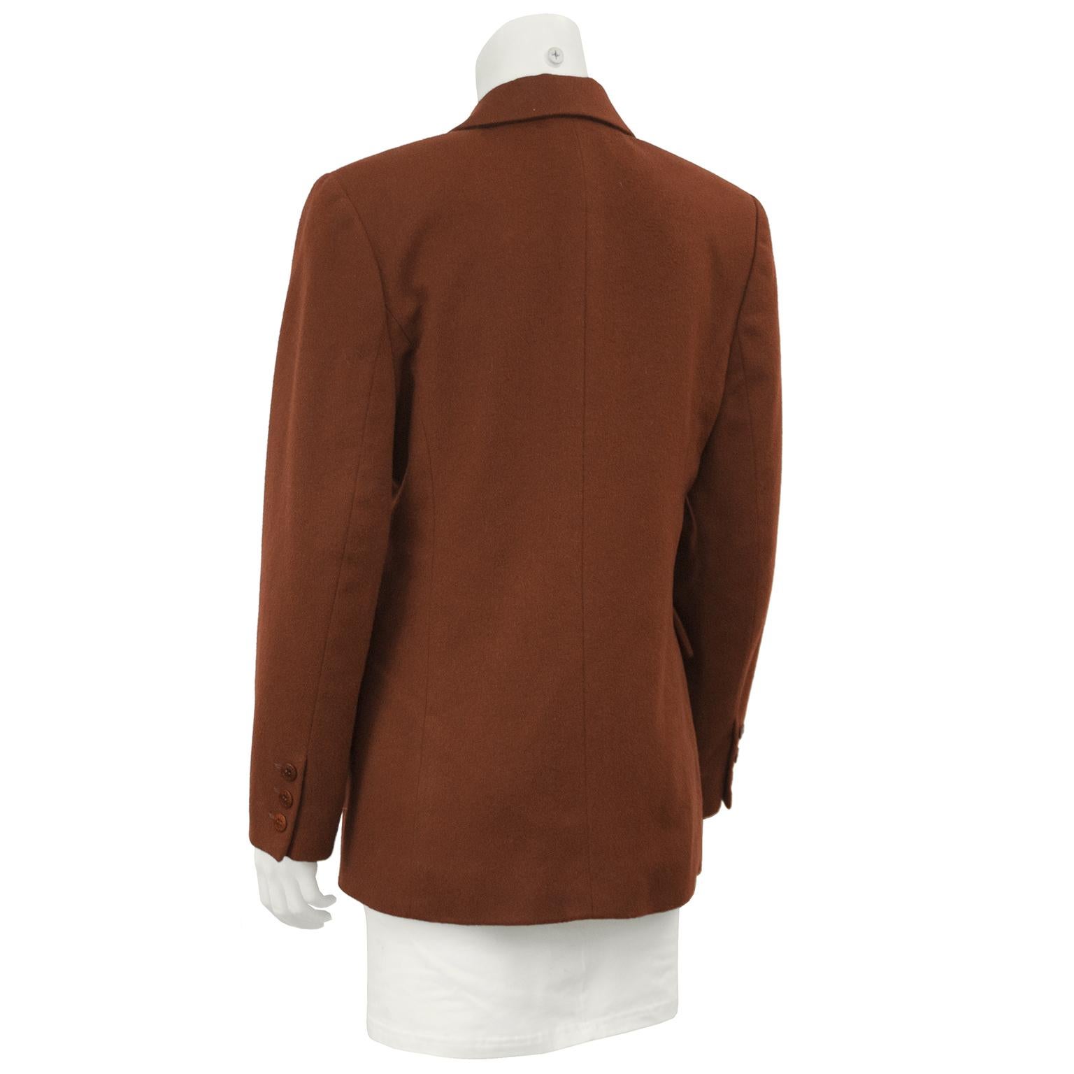 1990's rust colored cashmere Hermes jacket. Stunning classic double breasted shape with one breast pocket and two flap pockets on hip, all buttons original with Hermes Paris etched logo. Slightly fitted through the waist. Fully lined in rust and red