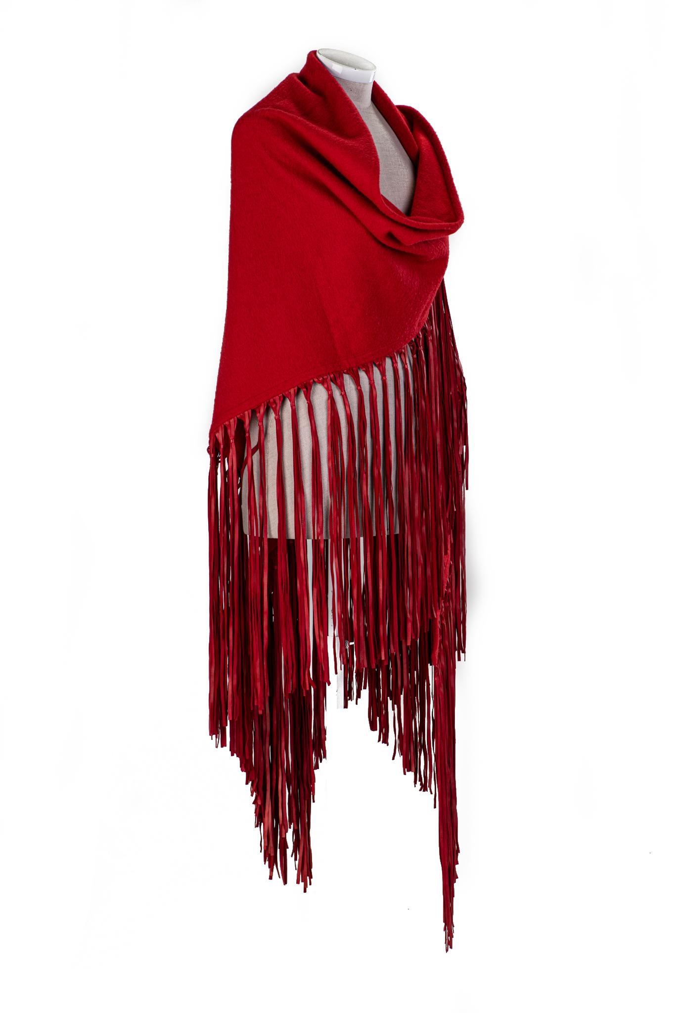 1990s Hermès red cashmere-and-wool shawl with extra-long leather fringe. Minor wear.
