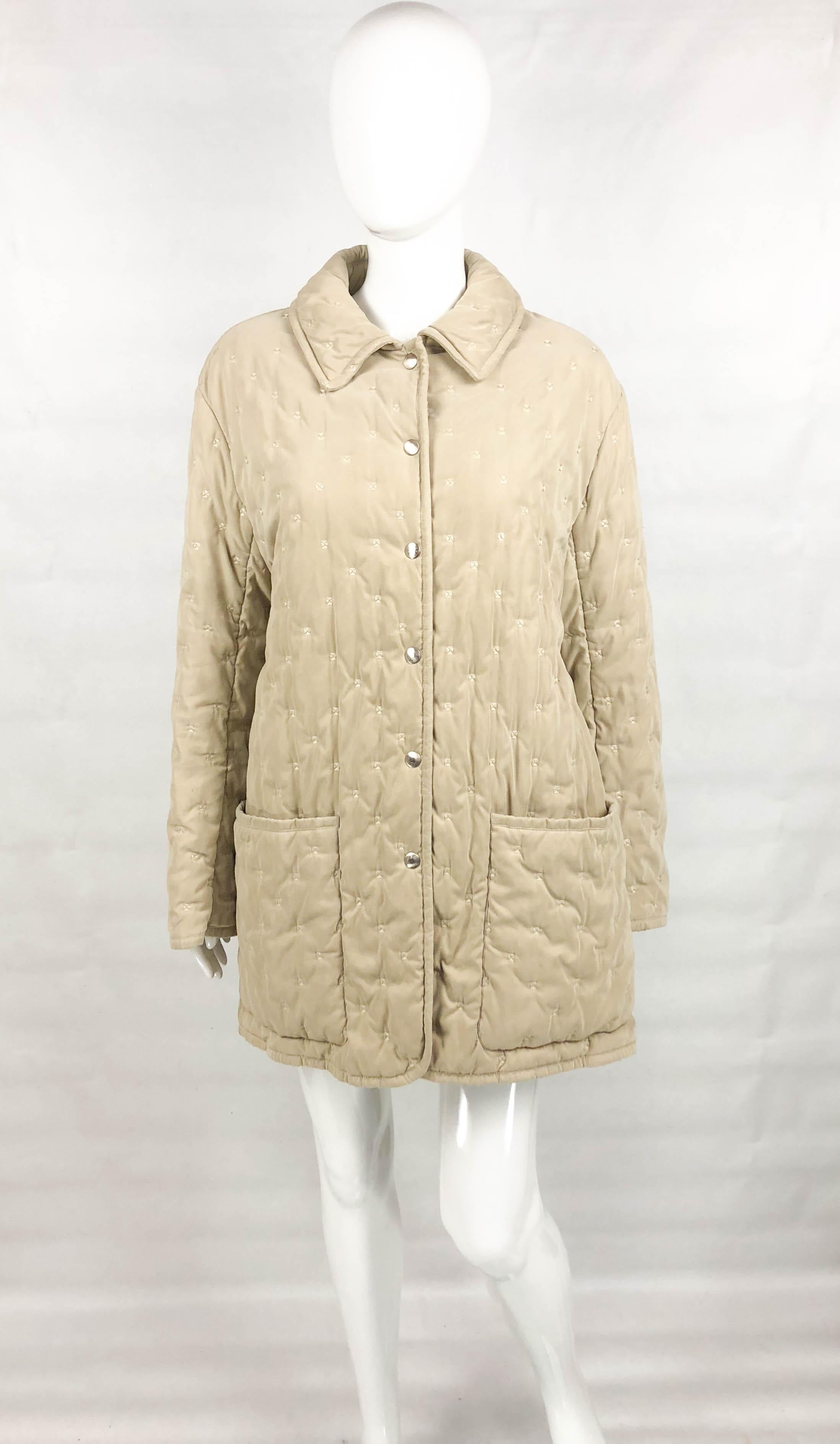 Vintage Hermes Taupe Quilted Jacket. This stylish quilted jacket by Hermes dates back from the 1990’s. Straight cut with stitched square detail, it has two large pockets on the front. There are 6 silver-tone pressure buttons down the front saying