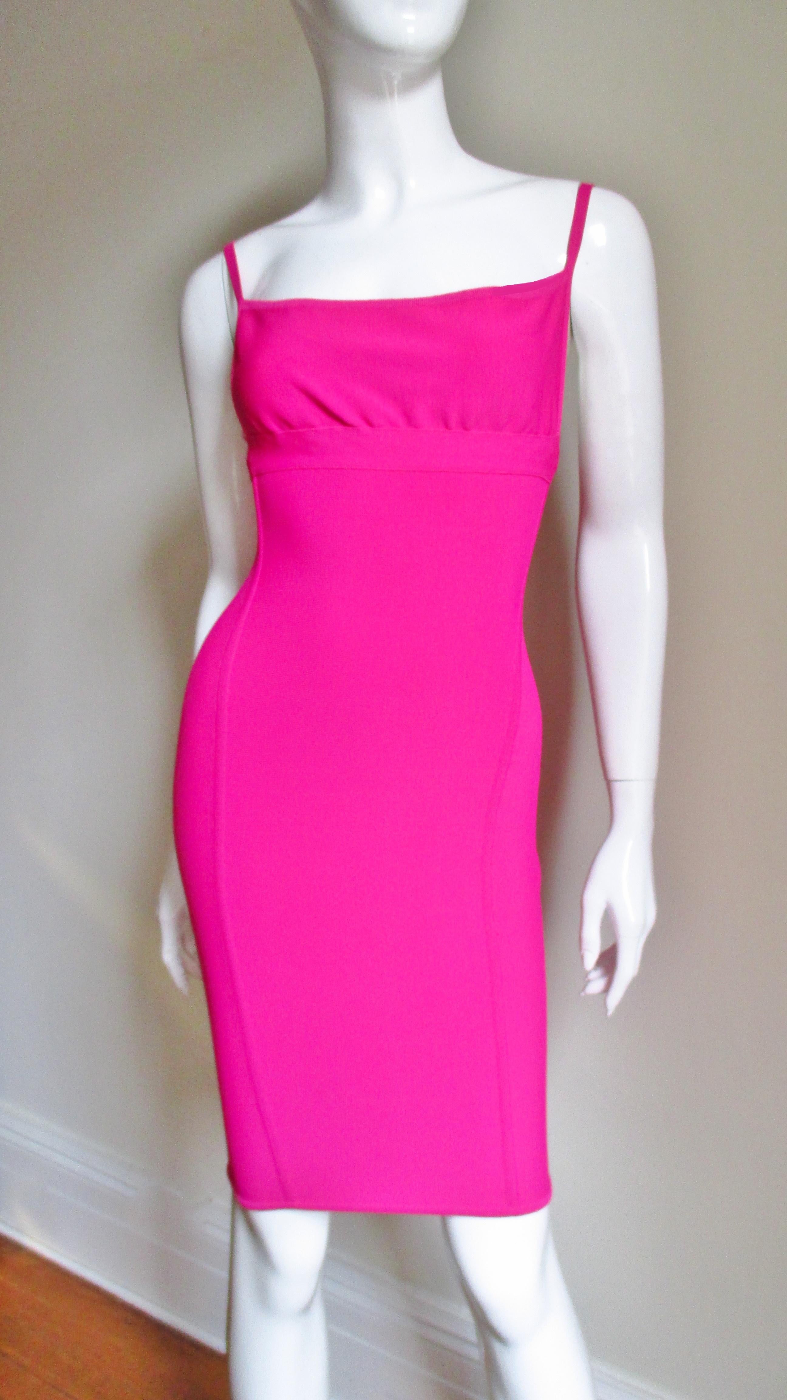 A beautiful bight pink fitted dress from master designer Herve Leger in his signature stretch fabric.  The dress has spaghetti straps and the body conscious fit he is famous for. It is unlined and has a matching back invisible zipper. 
Fits size