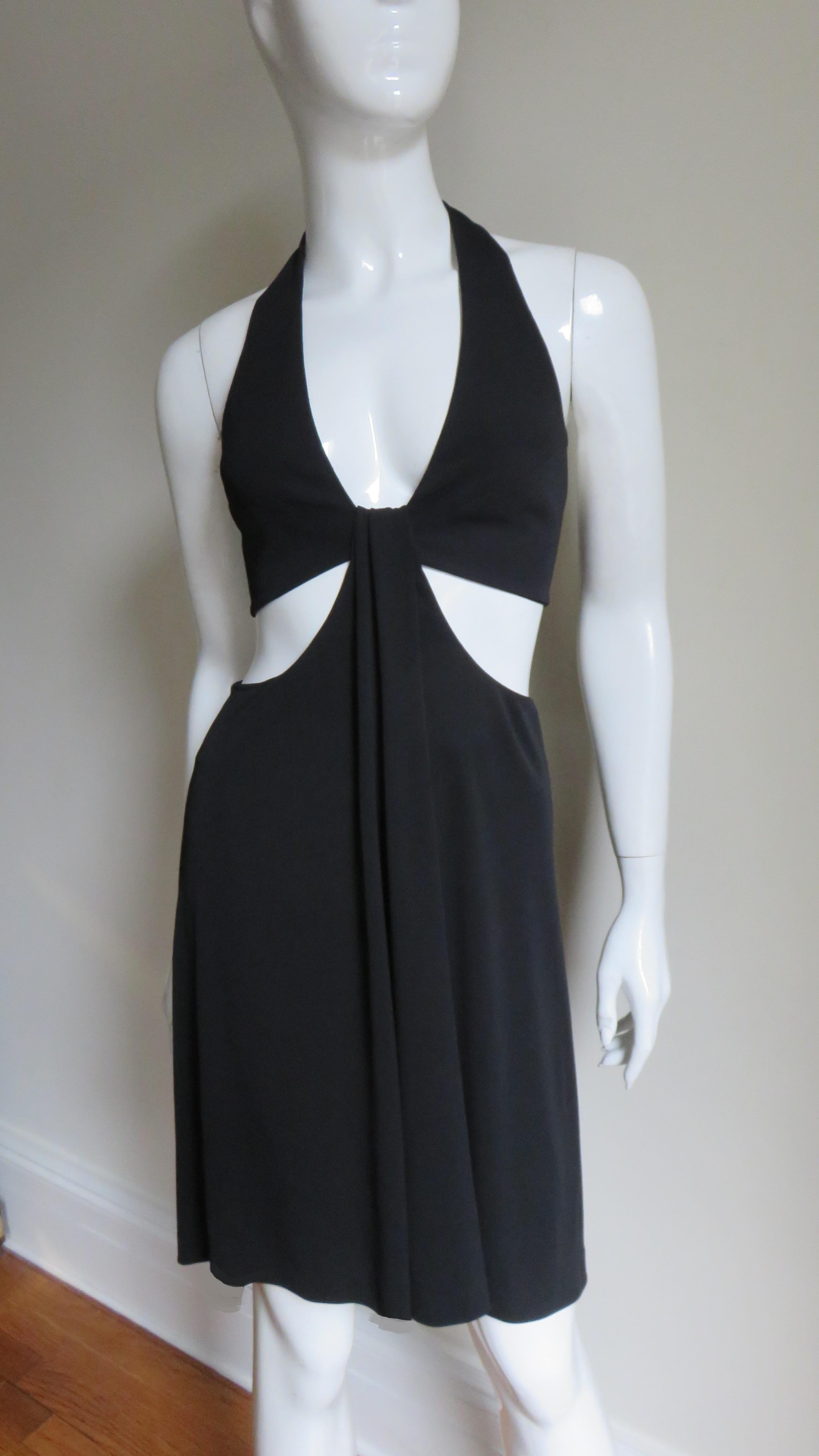 A gorgeous black jersey dress by Herve Leger. A master of enhancing the female form this dress is no exception with it's plunging halter neckline plus exposed back and side waist. The back of the dress is bare to just below the waist with the