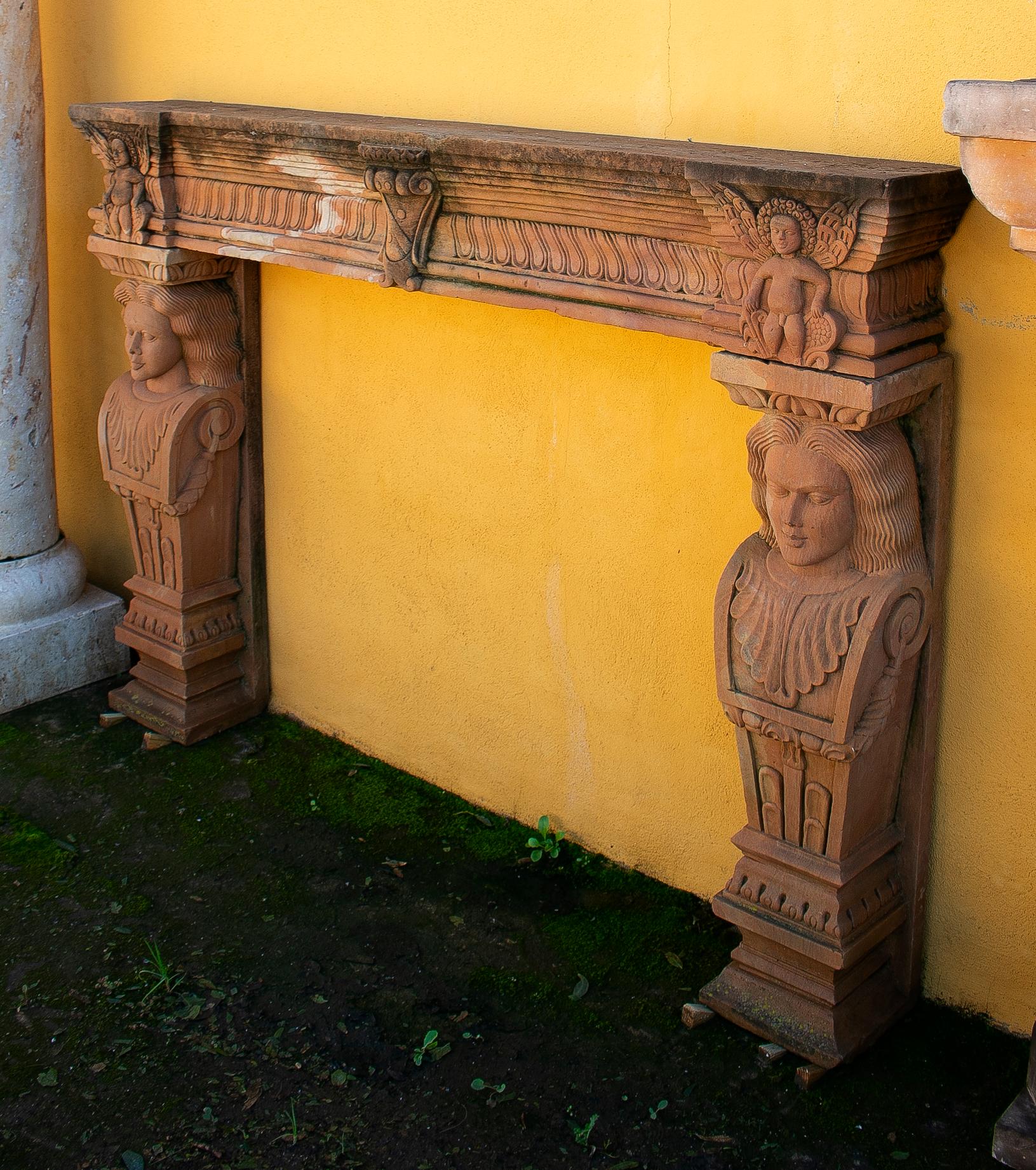 1990s Indian hand carved sandstone fireplace mantel (fireplace) with caryatid pilaster figure sculptures and geometric bas-relief decorations. 

Opening dimensions: 103 x 125cm.