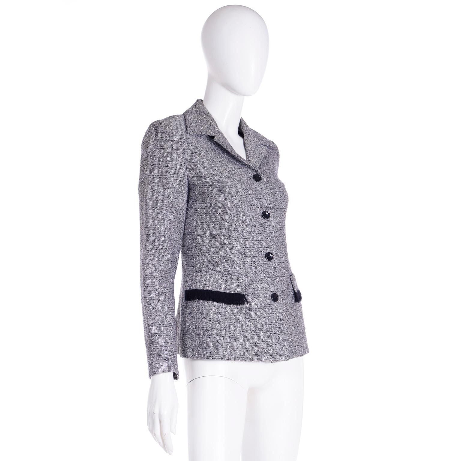 This vintage Isaac Mizrahi grey tweed jacket has black trim and black fringe. Isaac Mizrahi often made a nods to the American West in his collections and sometimes they were subtle, like the black fringe on the front pockets of this jacket! This