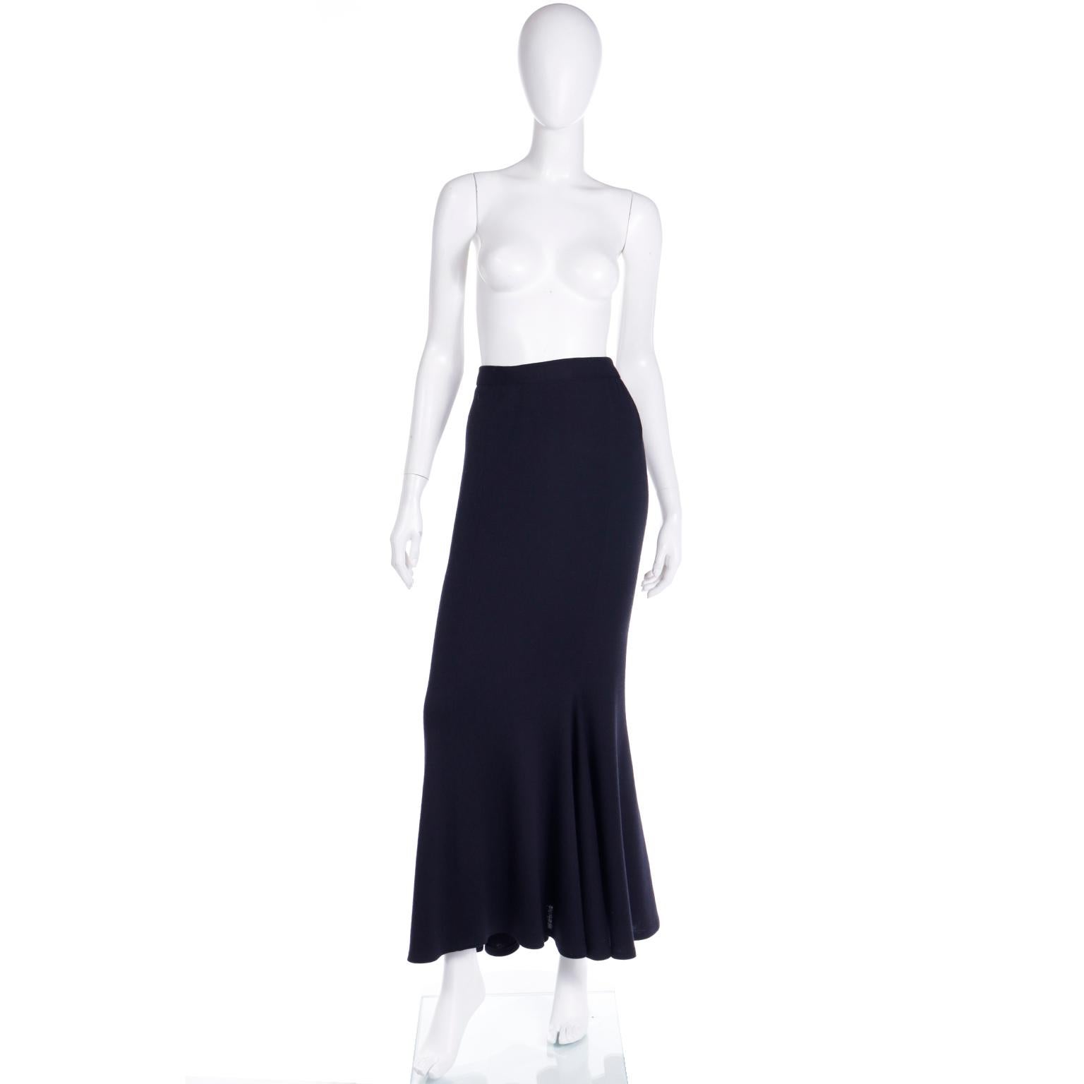 This stunning 1996 Isaac Mizrahi black wool skirt has a body hugging mermaid silhouette and is in a beautiful Wool with a slight amount of lycra for stretch. The skirt closes with a hidden side zipper and hook and eye with a button. This beautiful