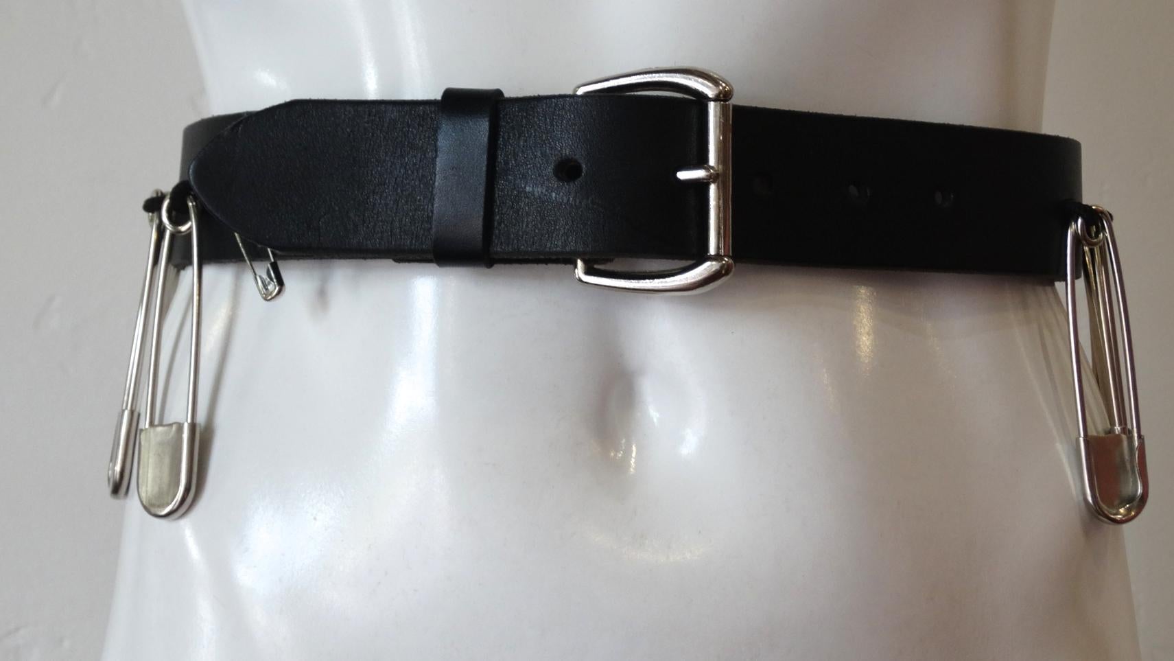Make Your Outfit All The Talk With This Isaiah Kincaid Belt! Circa 1990s, this black leather belt features silver hardware and is decorated with large safety pins. Throw on with trousers, jeans or even an oversized button up shirt dress! Marked a