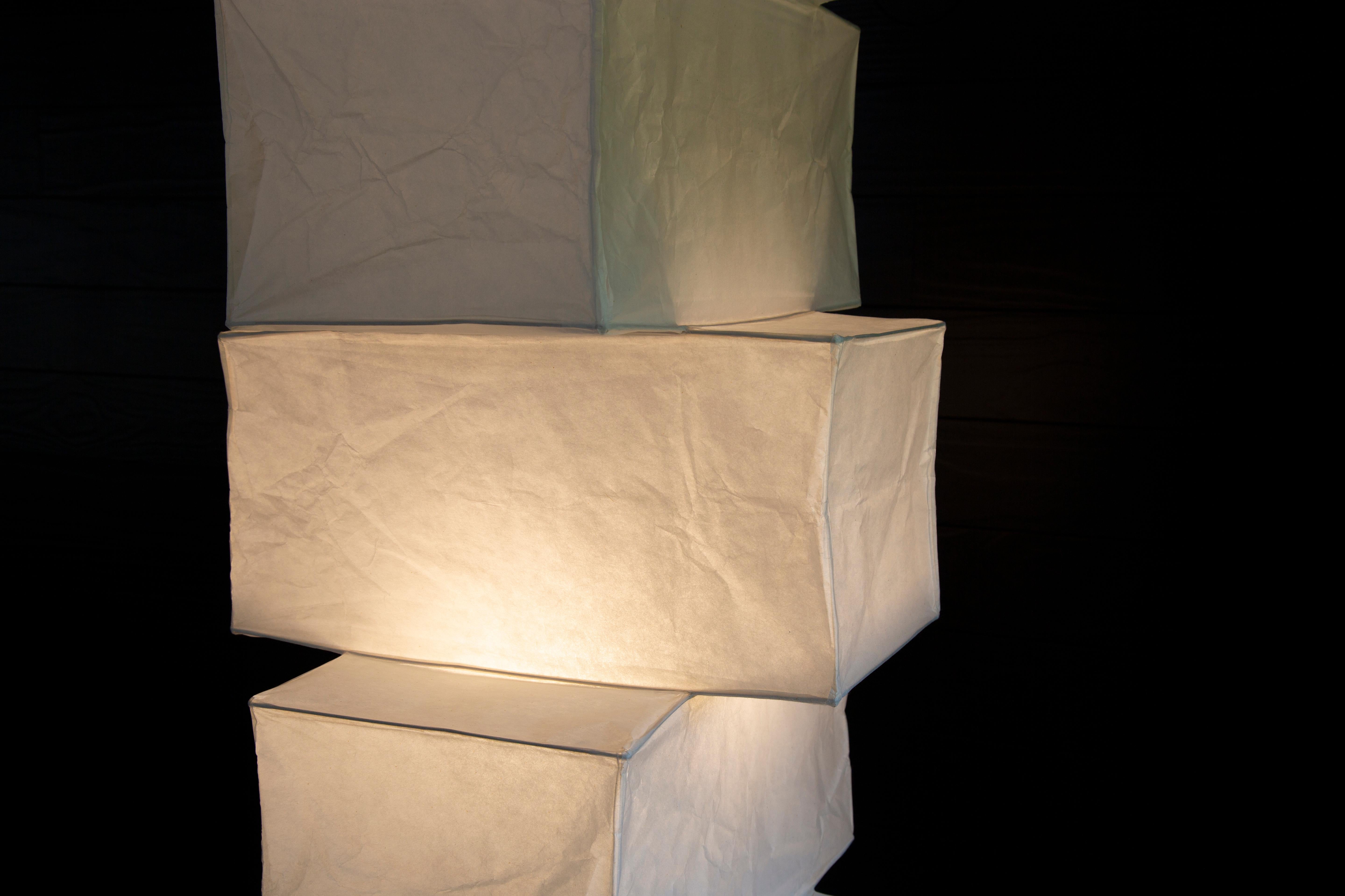Iconic modern design. This 1990s Isamu Noguchi UF4-L10 lamp consisting of one shade of 7 light boxes diffusing light from a single bulb. This lamp puts off a great soft light. Organic forms created from handmade Washi paper and bamboo ribbing