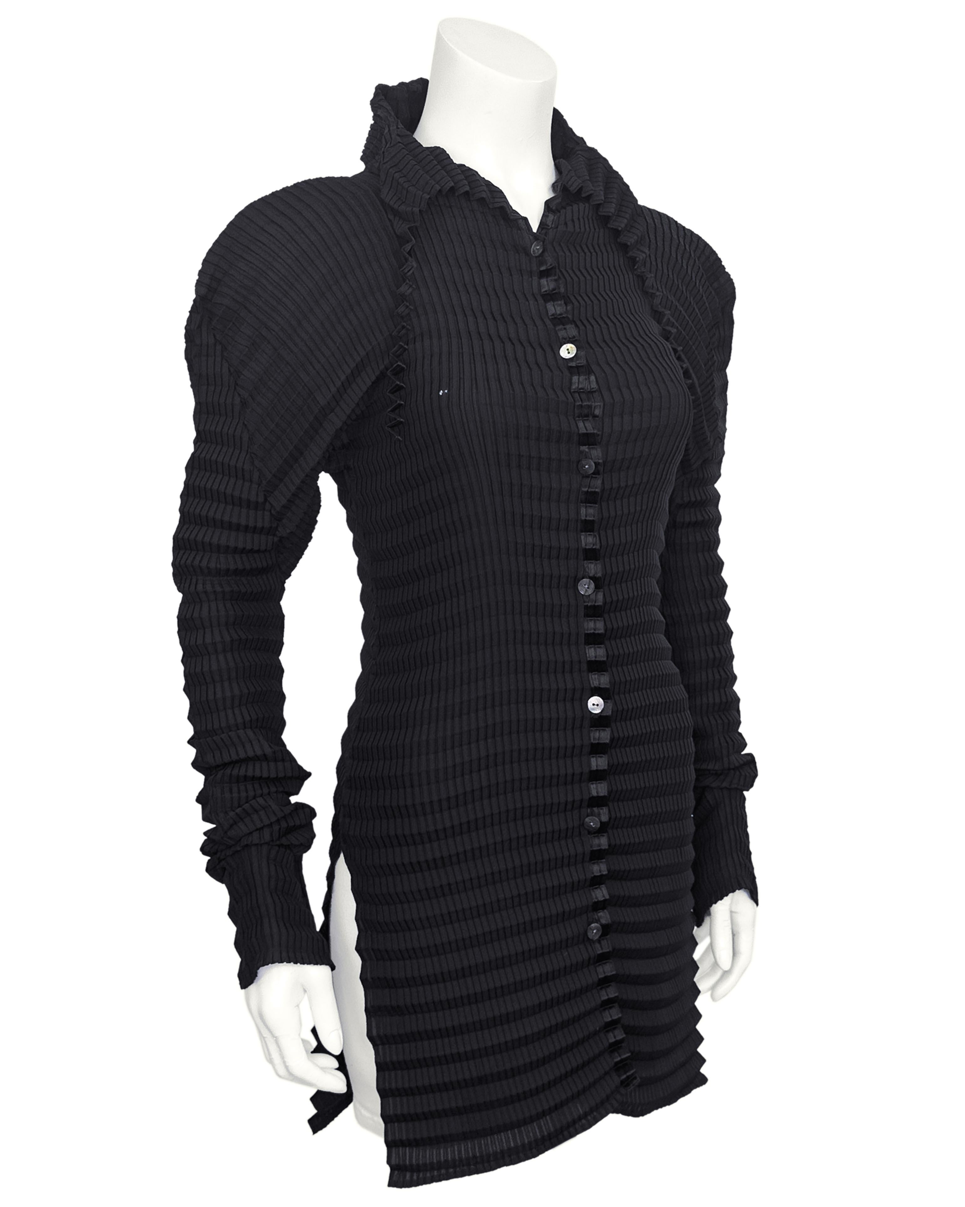 Elevate your wardrobe with this sculptural shirt from Issey Miyake from the late 1990s. This black plissé shirt exemplifies the brand's signature pleating technique with vertical micro pleats and larger horizontal pleats. Oversized puff shoulders