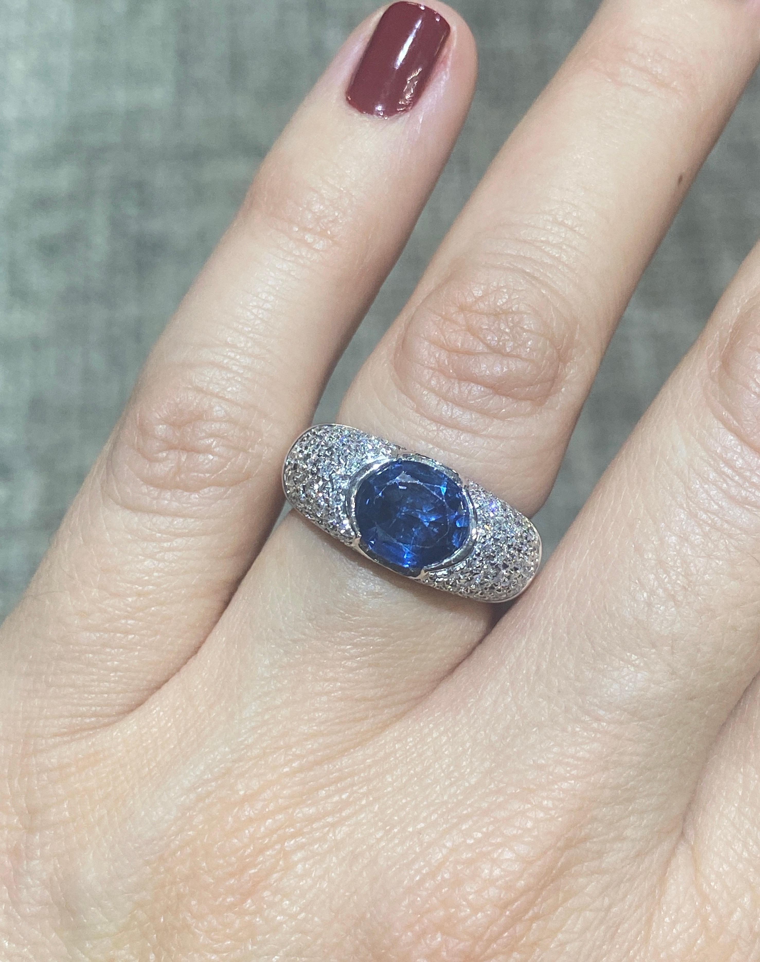 This striking 18 carat white gold, sapphire and diamond ring dates back to 1990s and is made in Italy. The centre Ceylon sapphire, which has no indication of any treatments is approximately 2 carat and the surrounding 98 round cut diamonds. weigh