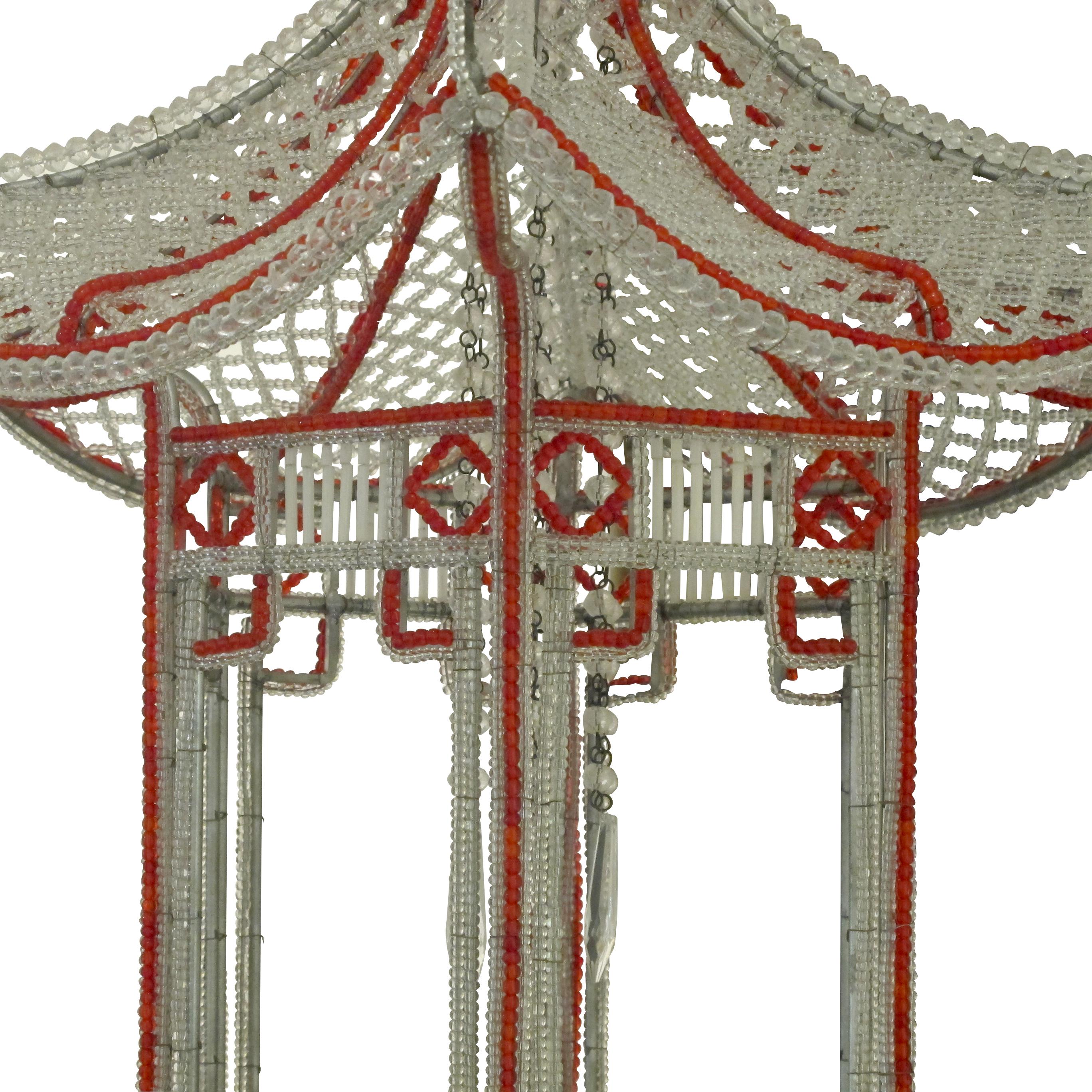 1990s Italian handcrafted beaded pagoda chandelier with clear and red glass beads. This is an exceptional and very well-made chandelier in the shape of a pagoda in the Venetian style. The centre of the chandelier holds long strings of beaded chains