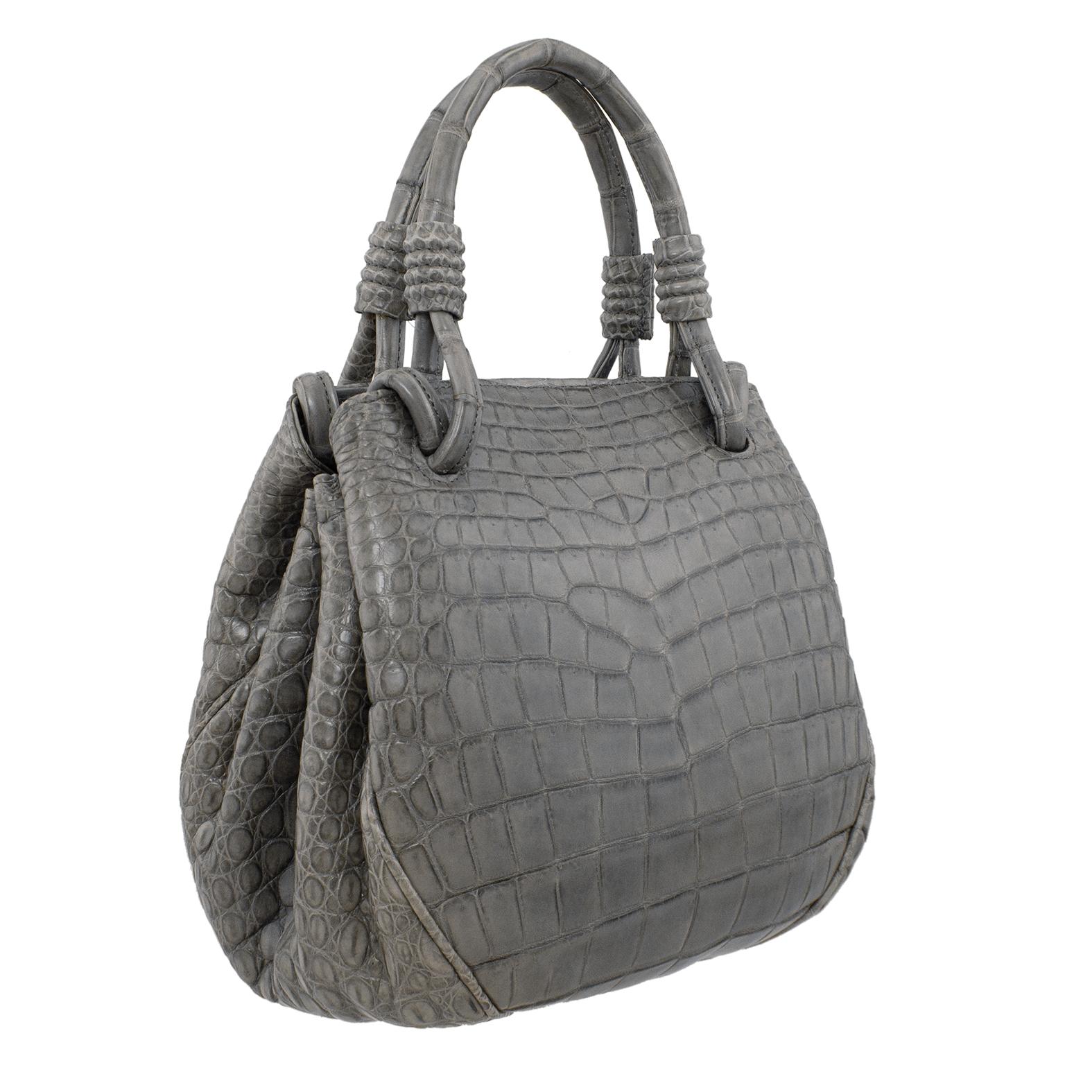 Just stunning supple matte grey reptile effect handbag made in Italy for high end Canadian retailer Davids in the 1990s. Great shape and size, slightly rounded with top handles. This bag looks like it is on the smaller size, but it opens accordion