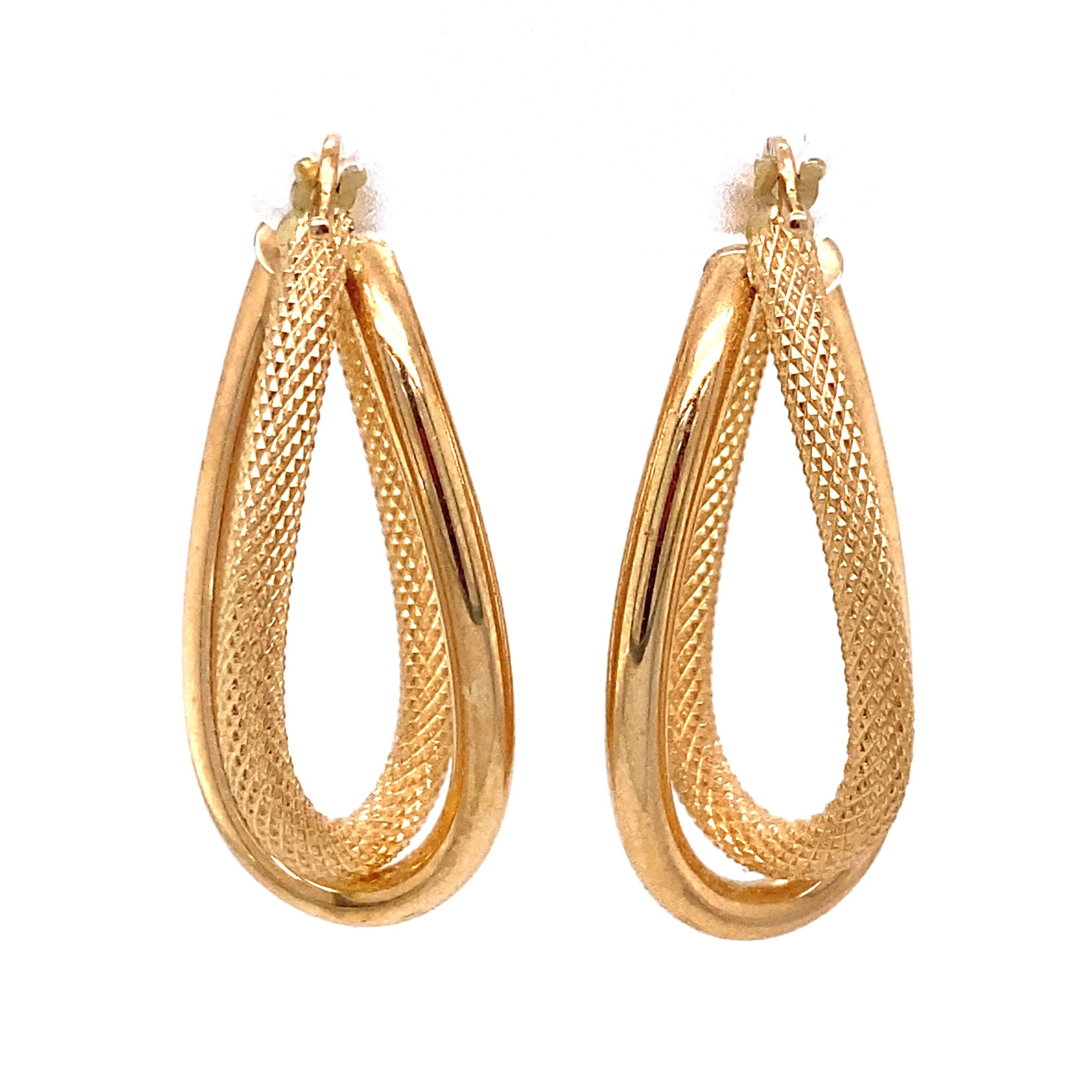 Circa: 1990s
Metal Type: 14 Karat Yellow Gold 
Weight: 2.8 grams
Dimensions: 1.25 inch Length

Item Details: A stunning pair of Italian gold hoops with a textured and brushed twisted hoop design. These are very light weight and the striking yellow