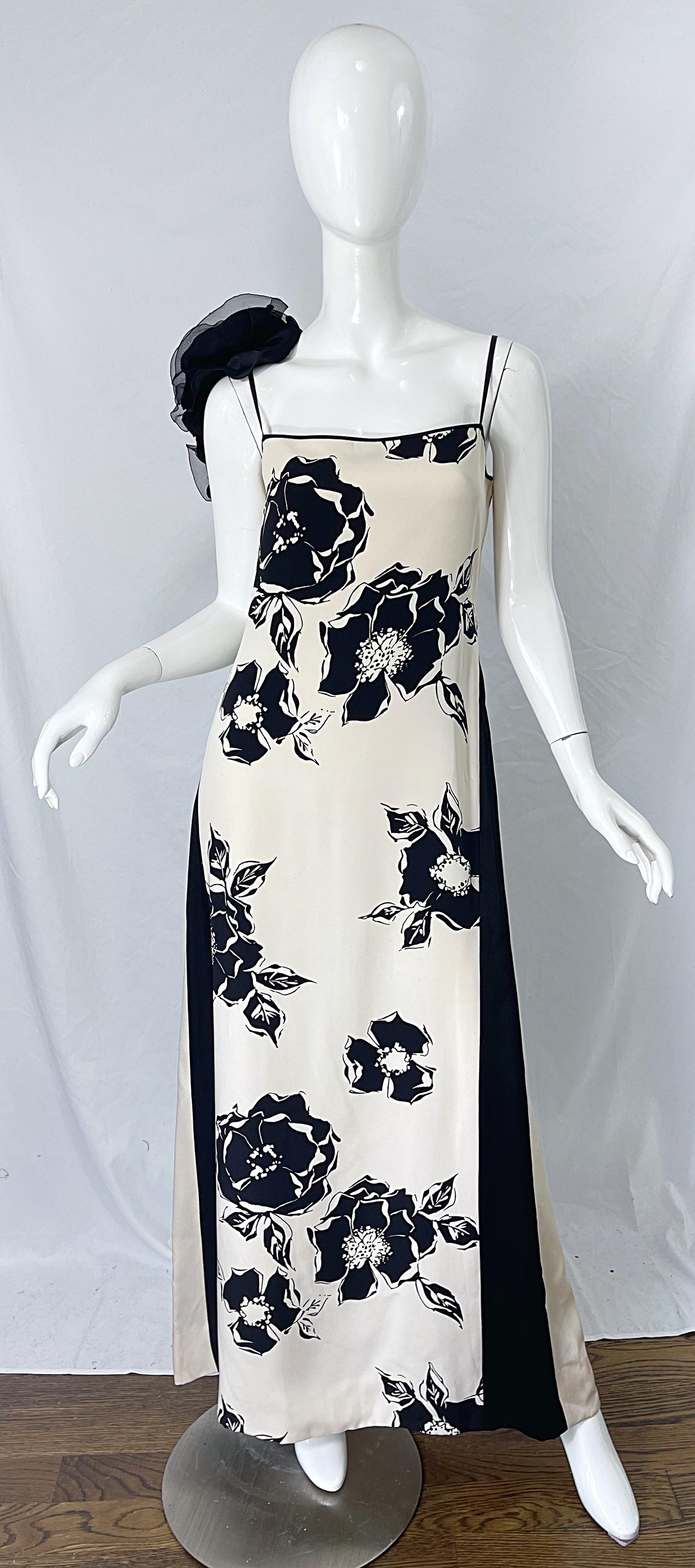 Documented and musuem worthy James Galanos  Couture Spring 1982 Runway black and ivory silk gown ! Features bold floral prints throughout, with contrasting slimming vertical stripes on the sides. Black silk chiffon rosette appliqués at back right