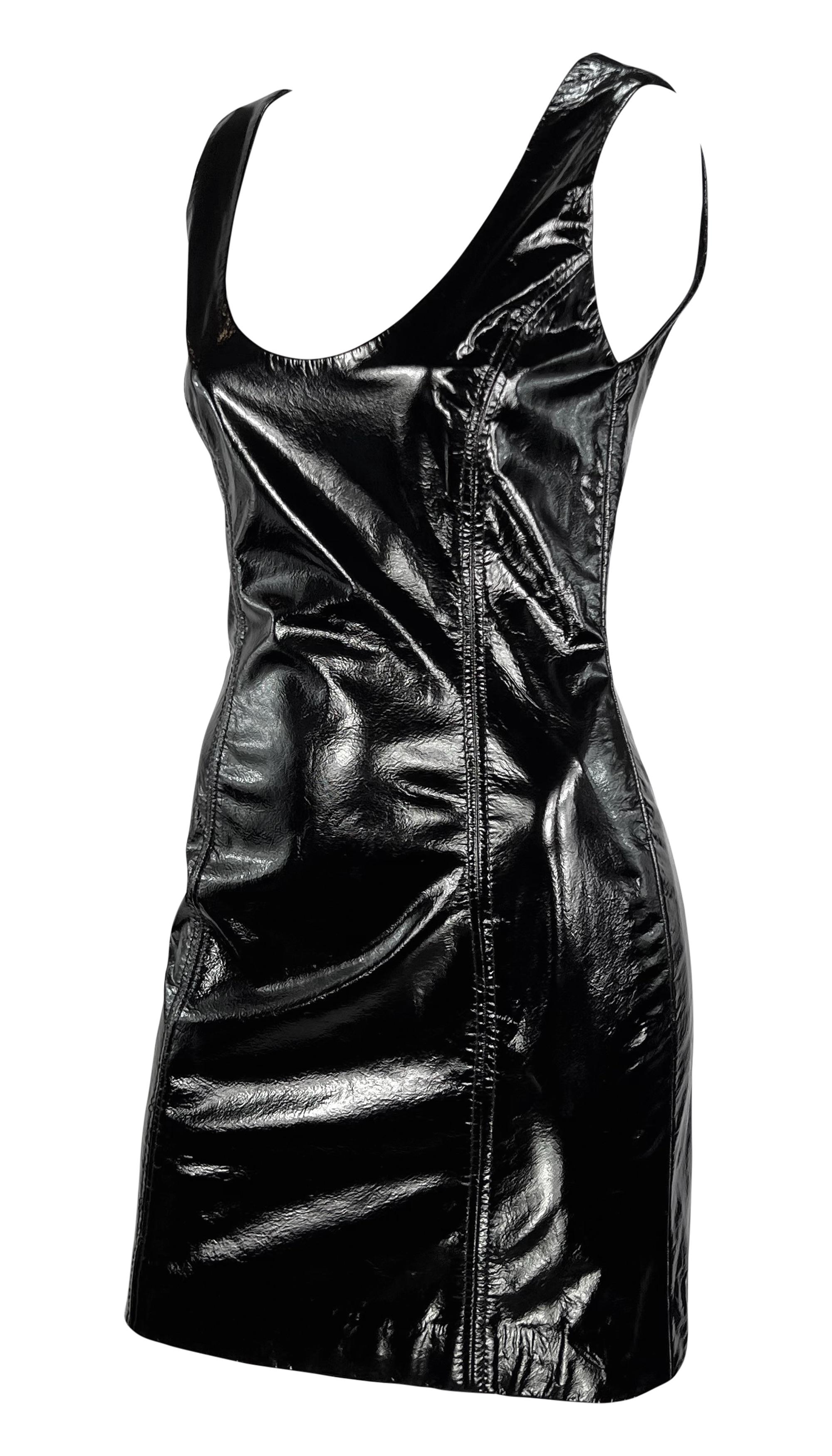 From the 1990s, this black patent leather Galanos mini dress is the perfect sexy LBD. Constructed entirely of black patent leather, this fitted mini dress features wide shoulder straps and a scoop necklace. 

Approximate measurements:
Size -