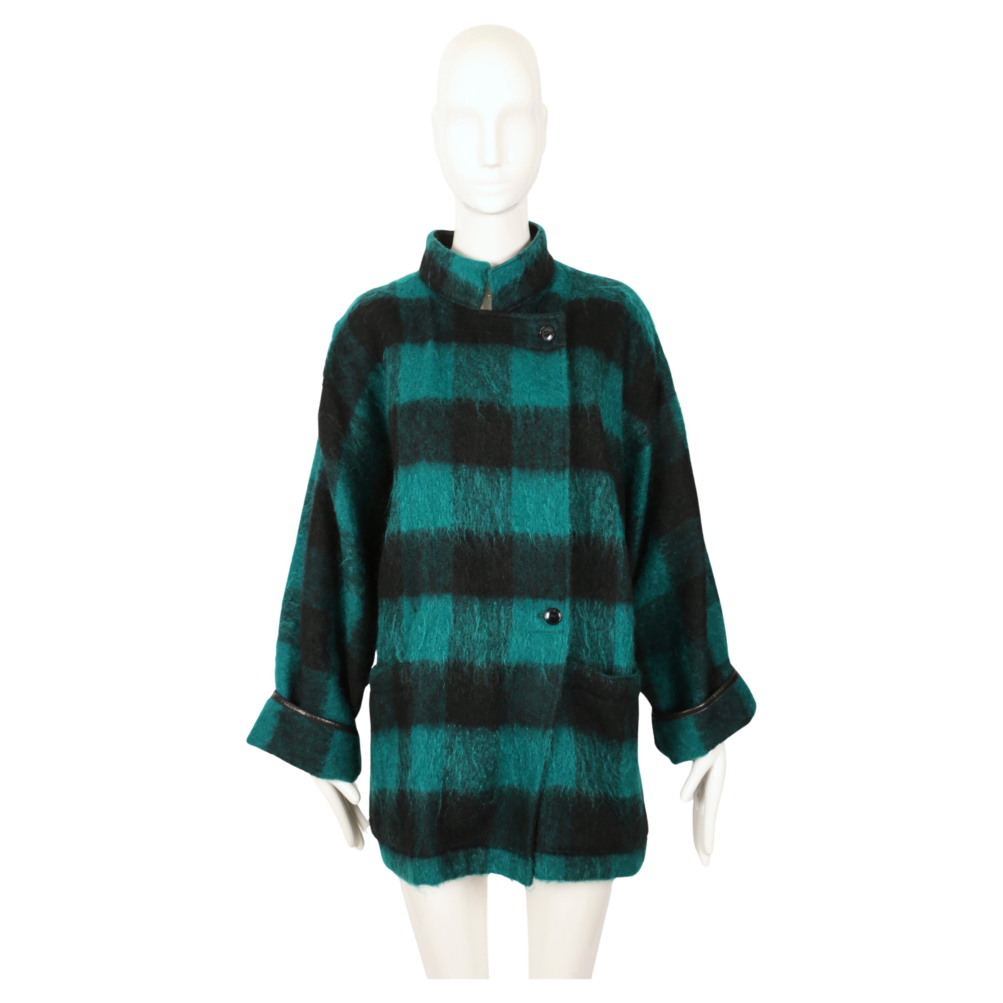 Stunning, jade green and black plaid brushed wool blanket jacket designed by Jean-Charles de Castelbajac dating to the late 80's early 90's. Labeled a size '2'. Snap closure.  Fits a variety of sizes. Was not pinned on the size 2 mannequin.
