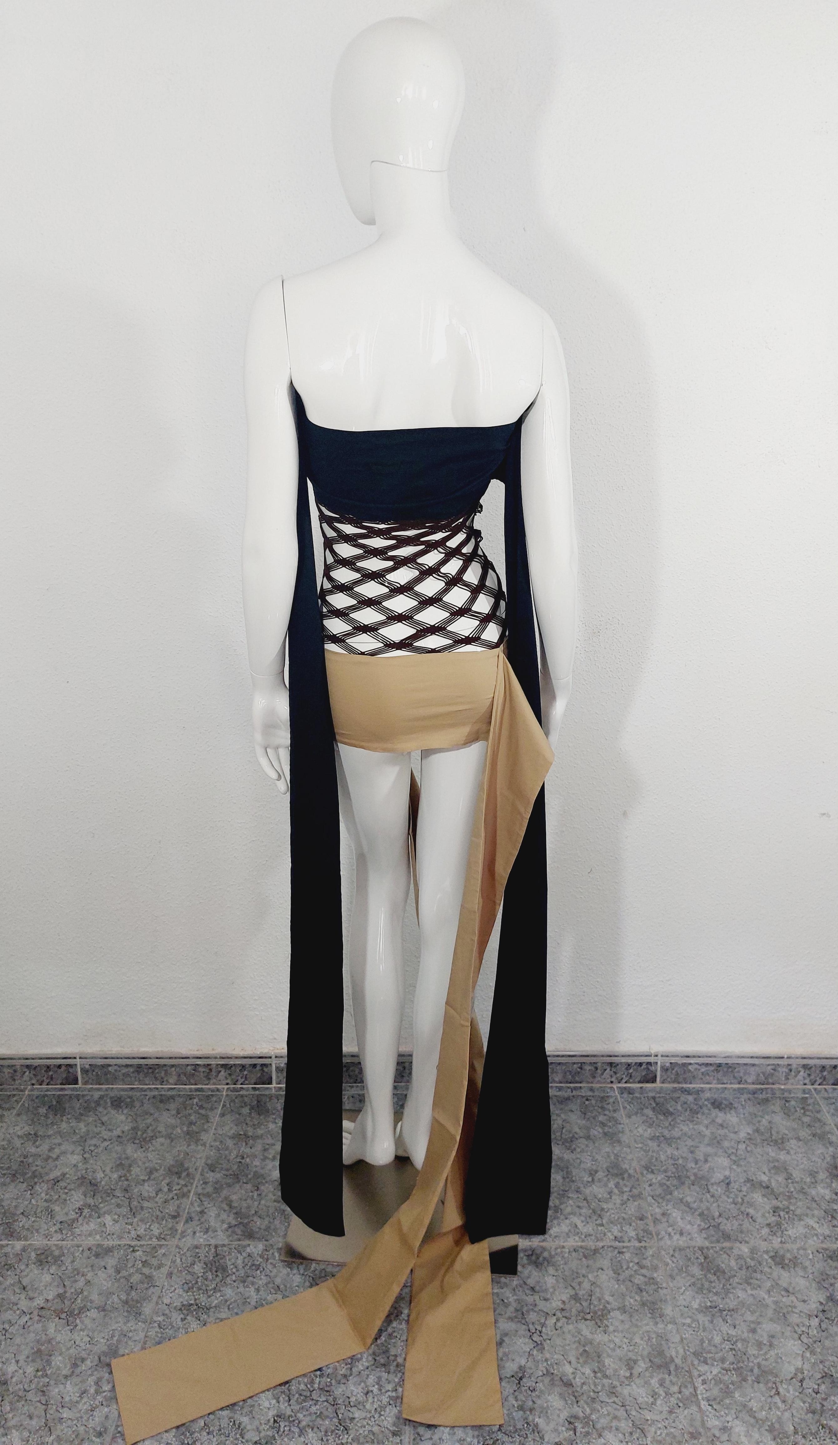 1990's Jean Paul Gaultier Black and Beige Strap With Net Panel Avantgarde Dress
Vintage Jean Paul Gaultier Dress. This striking dress by Jean Paul Gaultier dates back from the 1990’s. Of interesting design, it features black and beige body and brown
