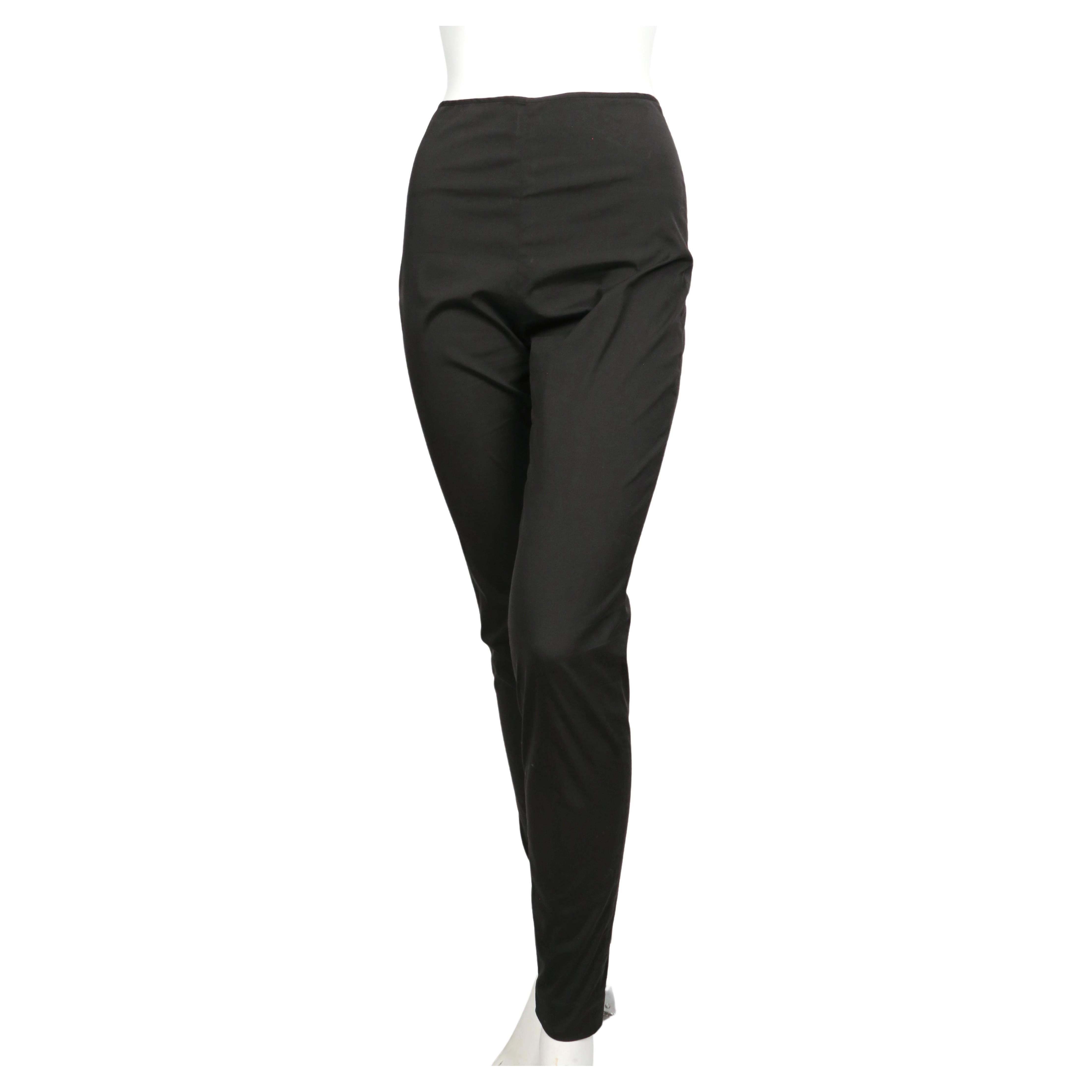 Black fitted high waist pants with ankle zippers designed by Jean Paul Gaultier dating to the late 1990's. French size 38. Pants were not clipped on French size 36 mannequin. Approximate measurements (unstretched), waist 25