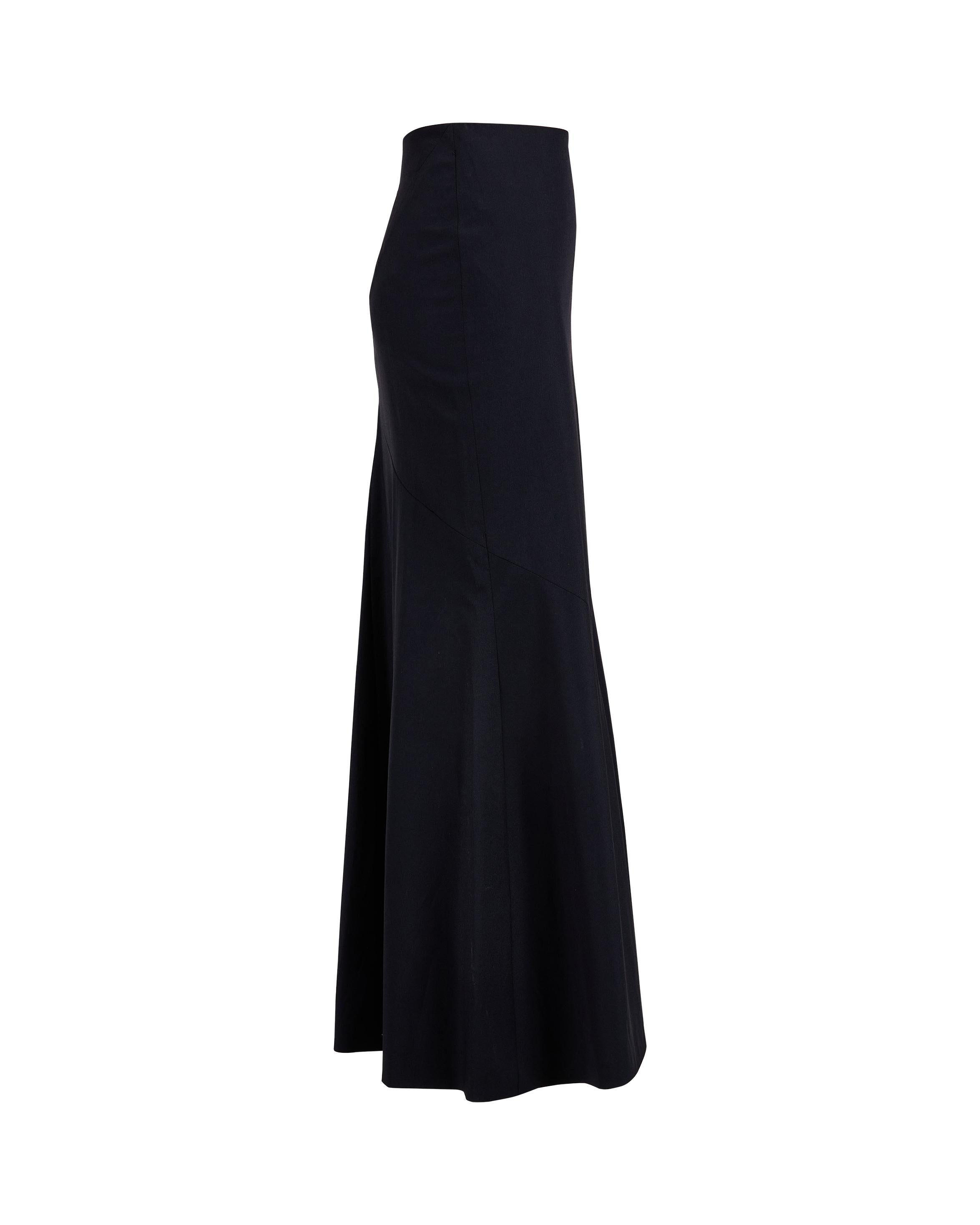 1990's Jean Paul Gaultier black wool fishtail maxi skirt. Fitted skirt with fishtail flare hem and side zip closure. Features two back holes for belt. In excellent vintage condition with no flaws to note.