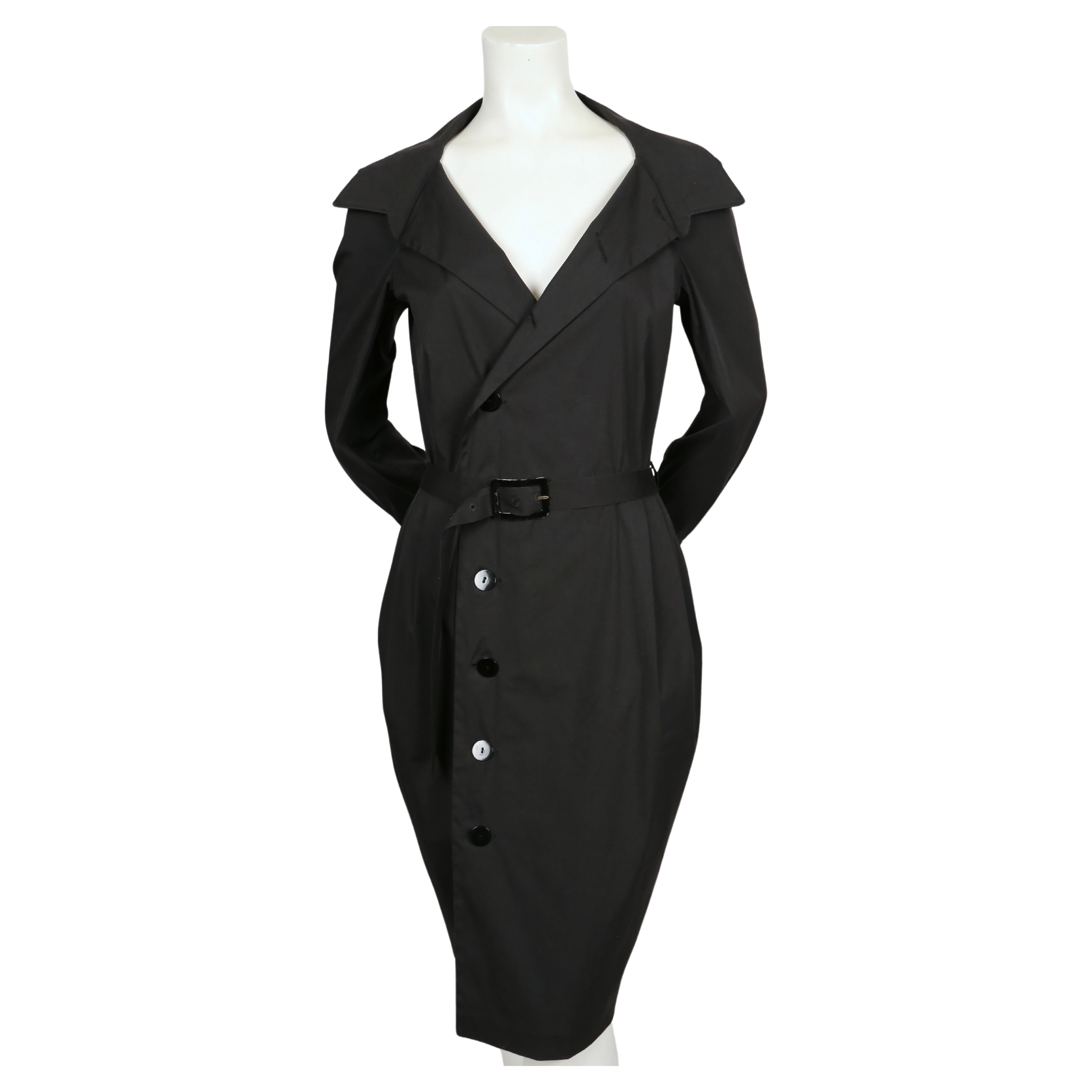 Black wrap style dress with enameled belt designed by Jean Paul Gaultier dating to the late 1990's. Labeled a French size 40 (Italian 44). Approximate measurements: 17