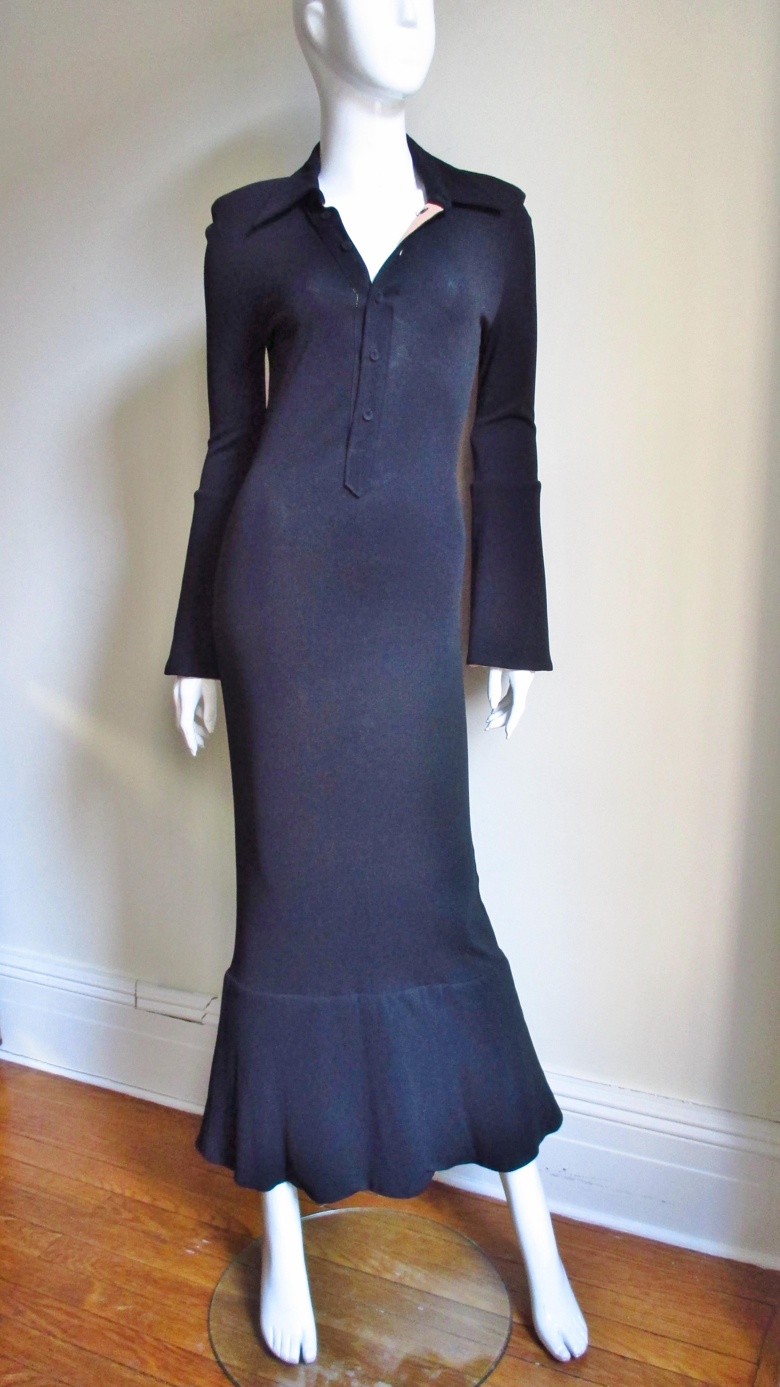 A fabulous black jersey dress from Jean Paul Gaultier's Classique collection.  It has long sleeves with subtly flaring cuffs flaring from just below the elbow which are camel colored underneath.  It has a shirt collar, small shoulder pads and a