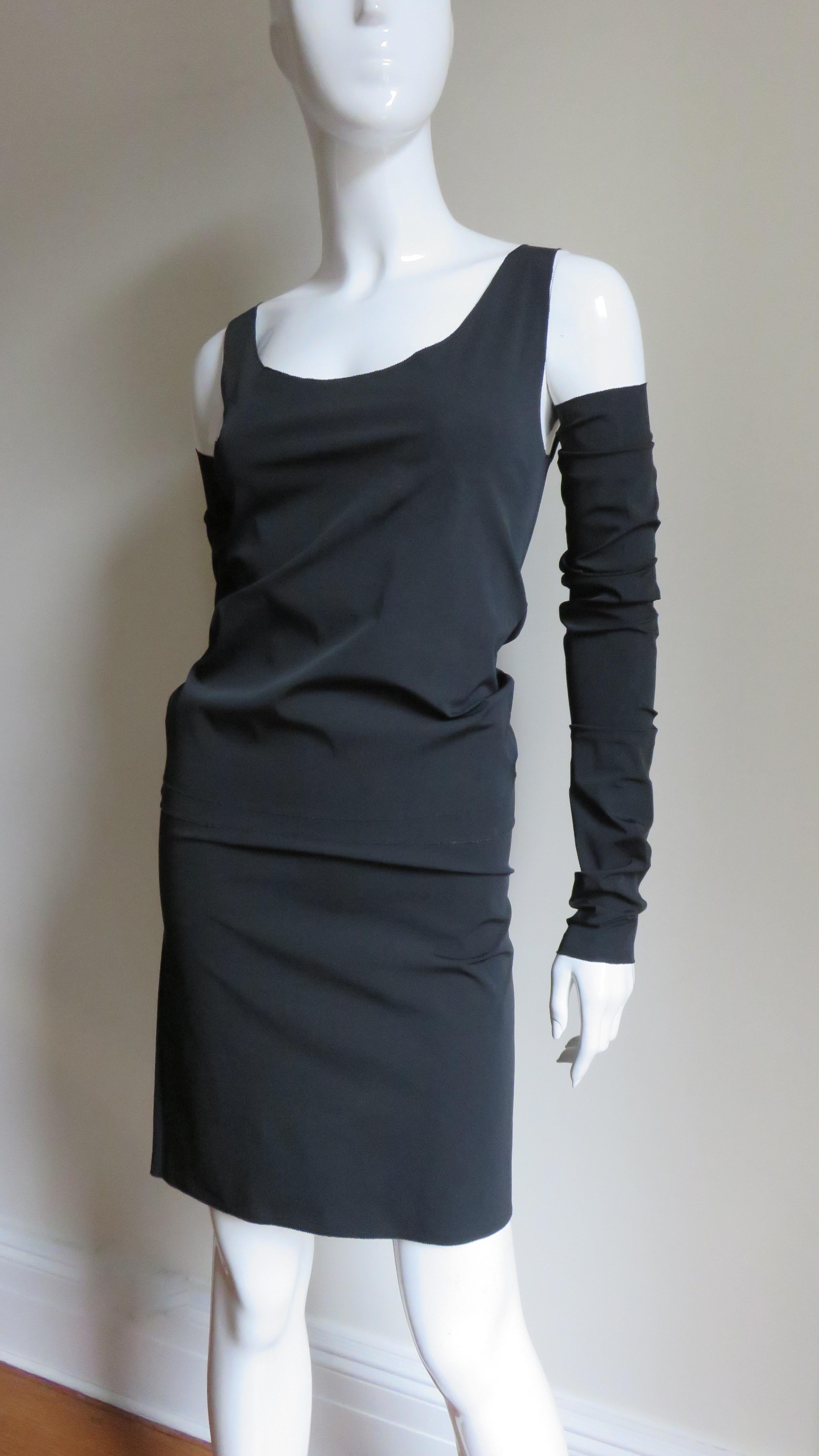 A fabulous 2 piece black top and skirt with separate sleeves from Jean Paul Gaultier.  The top is sleeveless with a scoop neckline and the skirt is straight.  The 2 separate long sleeves can be ruched on the arm.  All have stretch and slip on