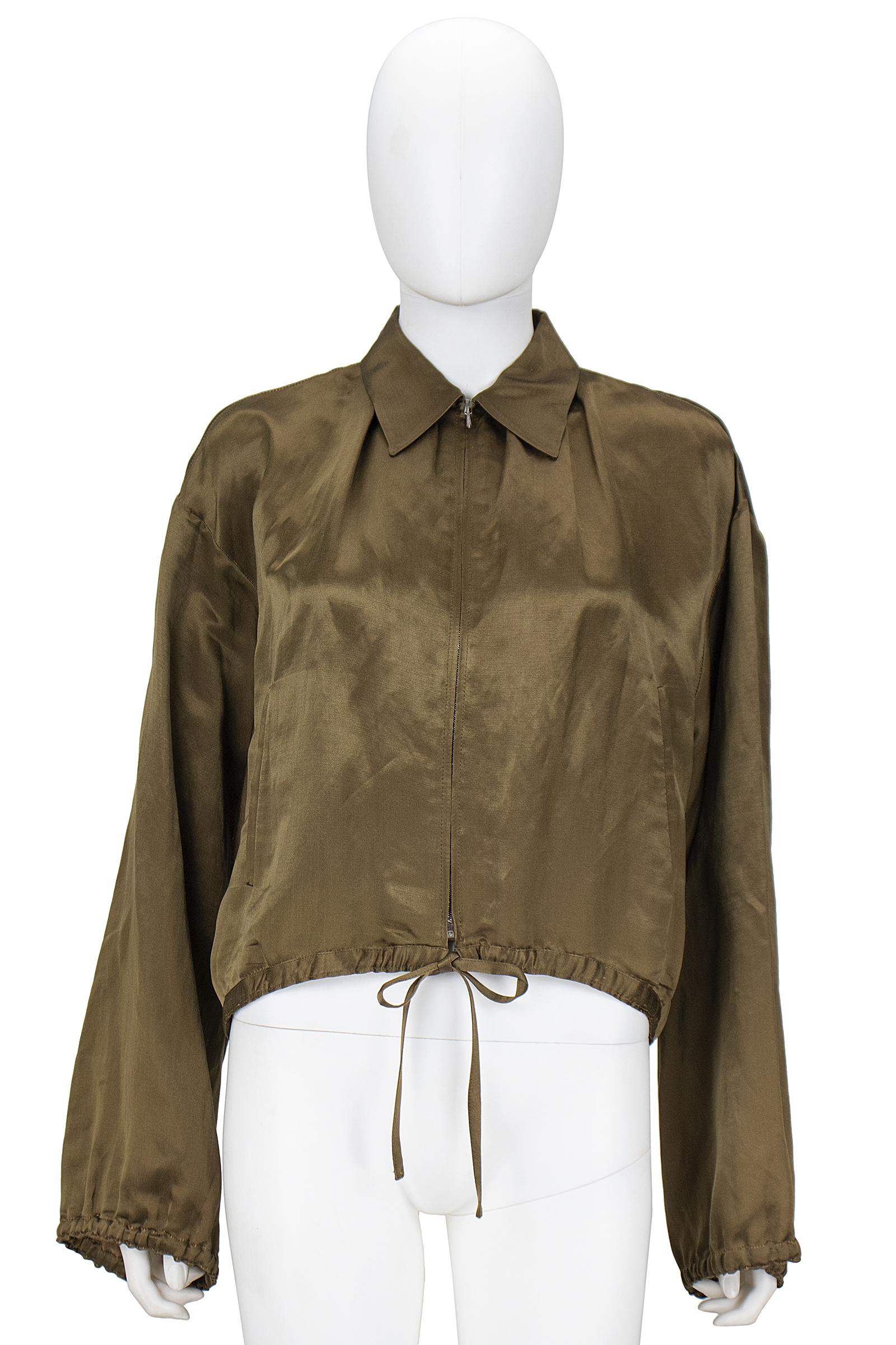 Jean Paul Gaultier crop bomber jacket
Olive silk lined in linen 
Gathering details 
Silver zipper closure with tie at waist 
Size 10 
Made in Italy 

*Please feel free to contact us with the 