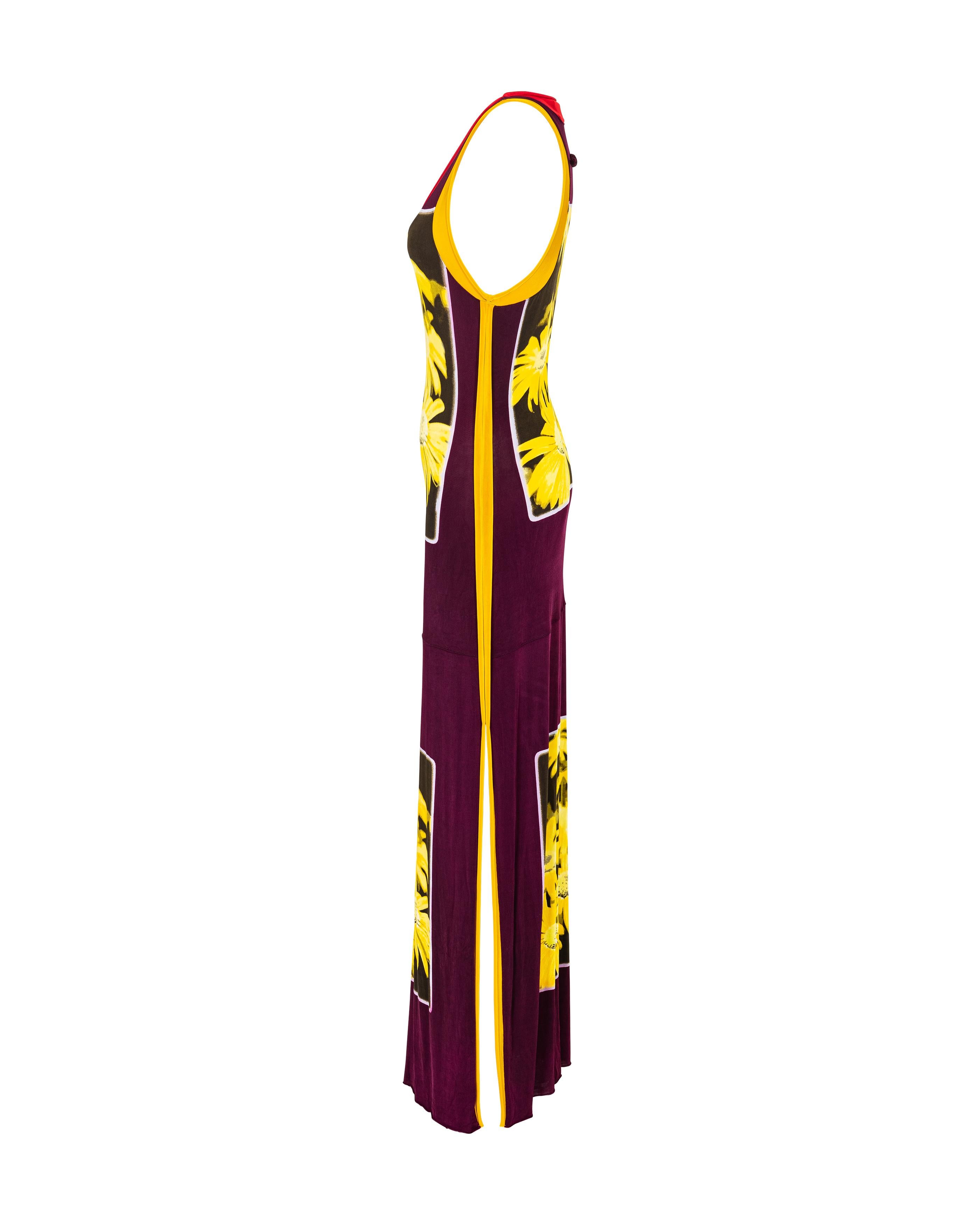 1990's Jean Paul Gaultier scoop neck floral print jersey maxi dress. Sleeveless warm purple dress with yellow floral print and red and yellow contrast trim creating sport-inspired motif. Features side slits at both sides and raw cut hem, with
