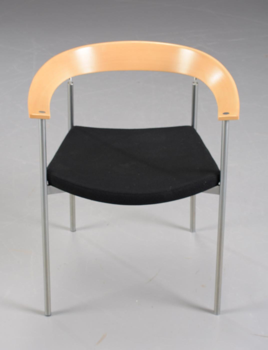 Danish stackable Johannes Foersom armchairs designed in 1998 in tube steel, beech, chrome and black leather made by Paustian.

The chairs feature elegant organic round shaped arm- and backrest in beech and frame in tube steel and chrome