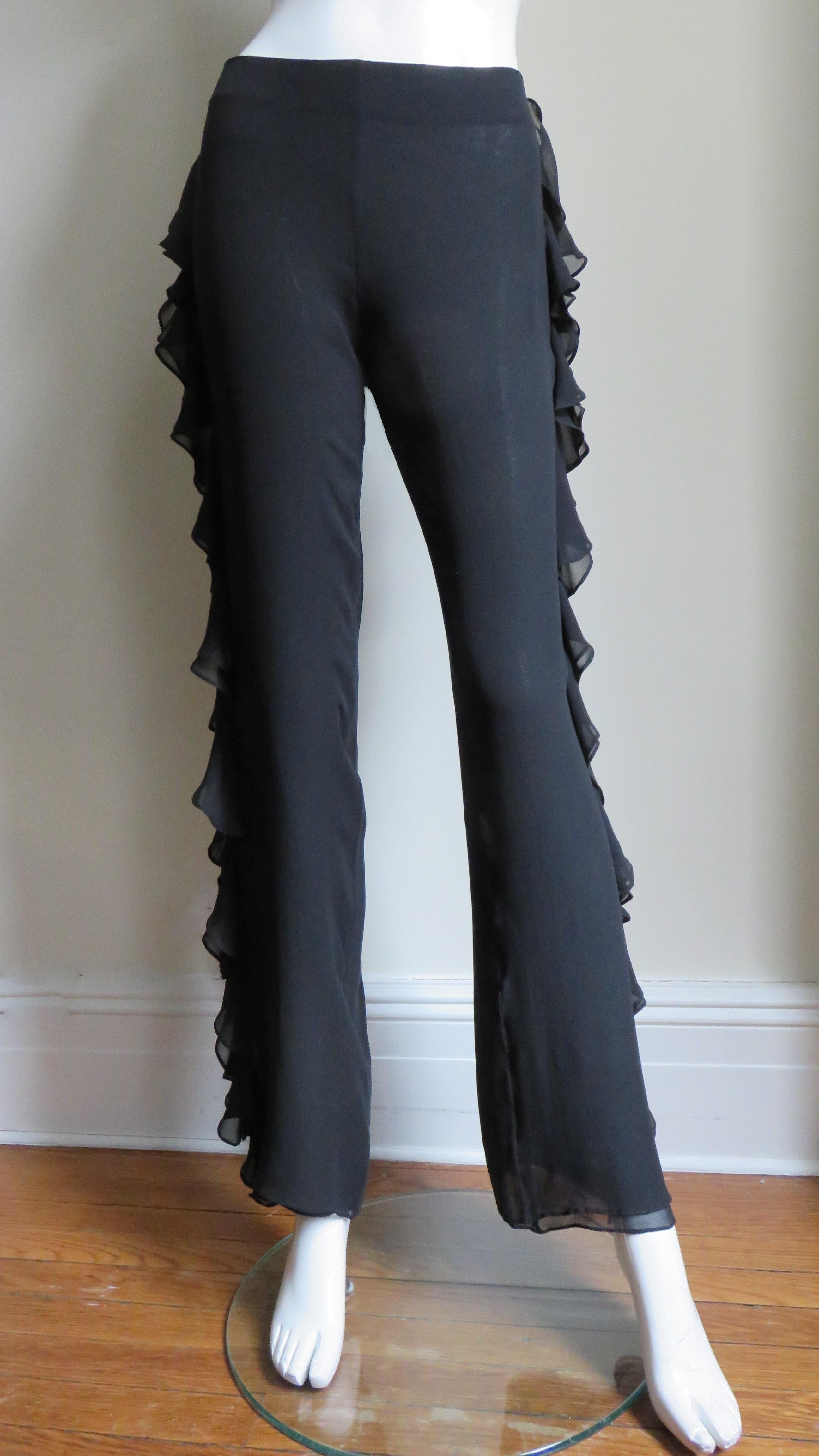 Beautiful John Bartlett black silk pants with a double layer of ruffles along the entire length of the outside of each side. The pants sit just below the waist, have straight legs, a side zipper and are lined in the same fabric.
Fits size Small,