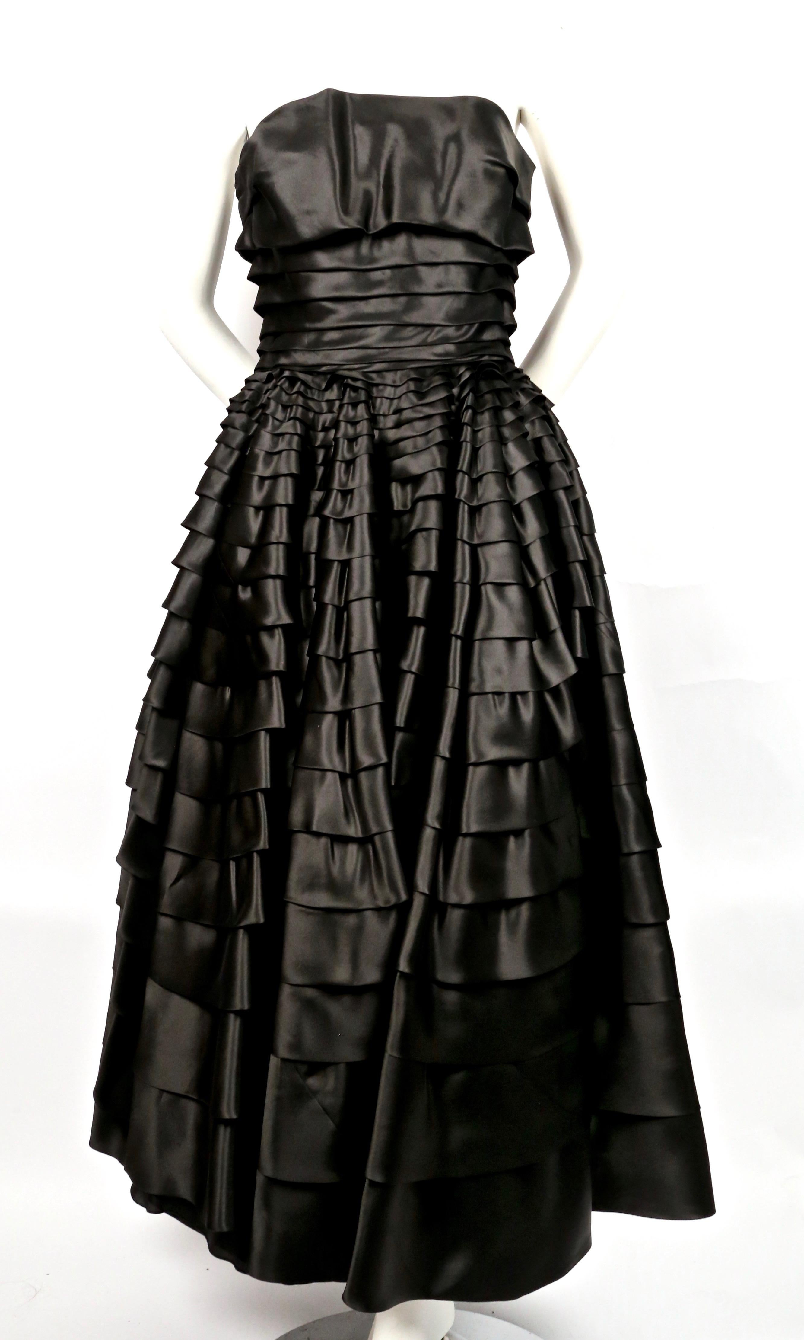 Stunning, jet-black silk, strapless dress with ruffles designed by John Galliano dating to the 1990's. Dress is labeled a French size 40 however it has been professionally altered by adding some fabric to bodice. Approximate measurements: bust 34