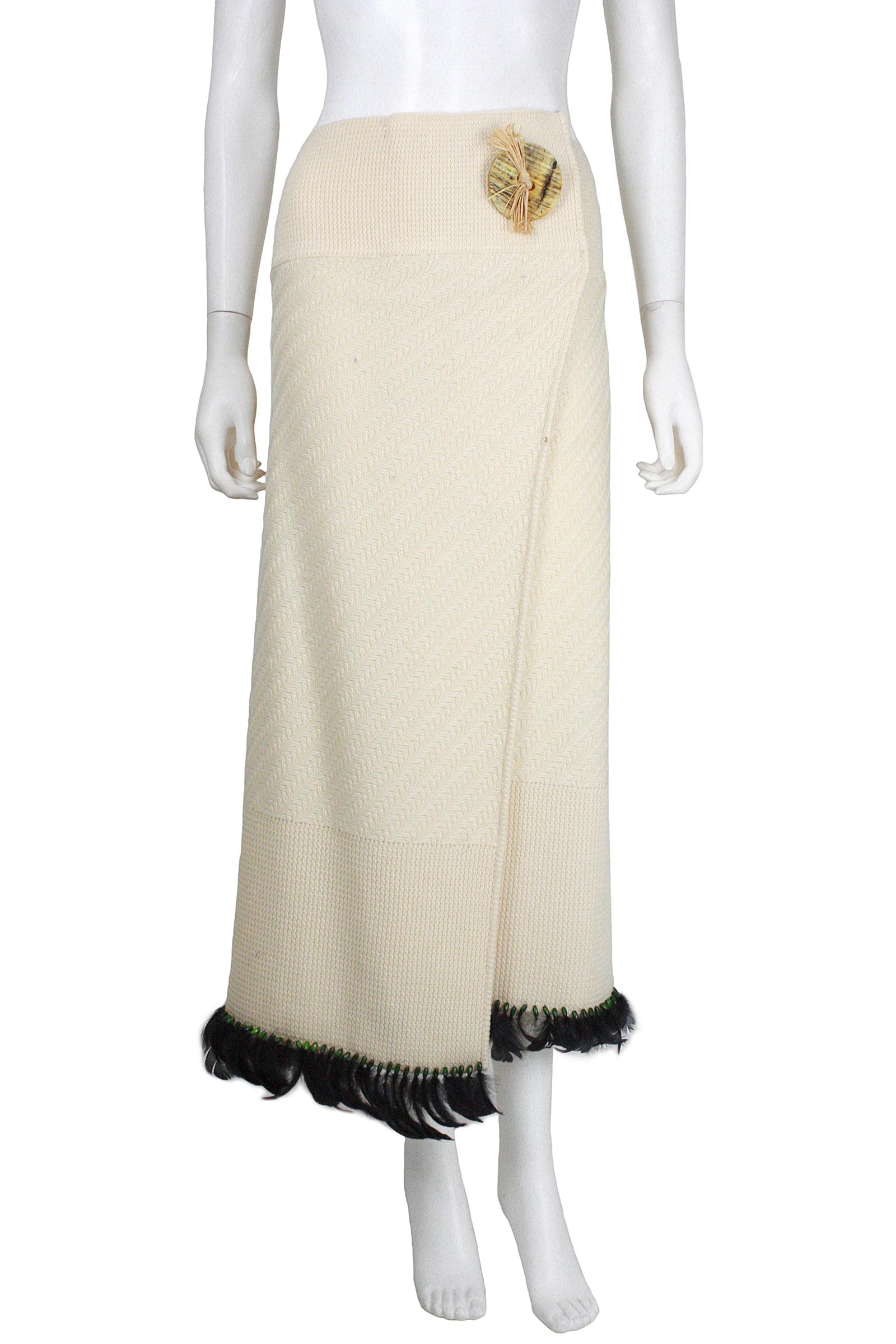 John Galliano 
Wool cream knit wrap skirt 
Large circular ornamental button with straw  
Made in Italy 
Black feather and green bead trim 