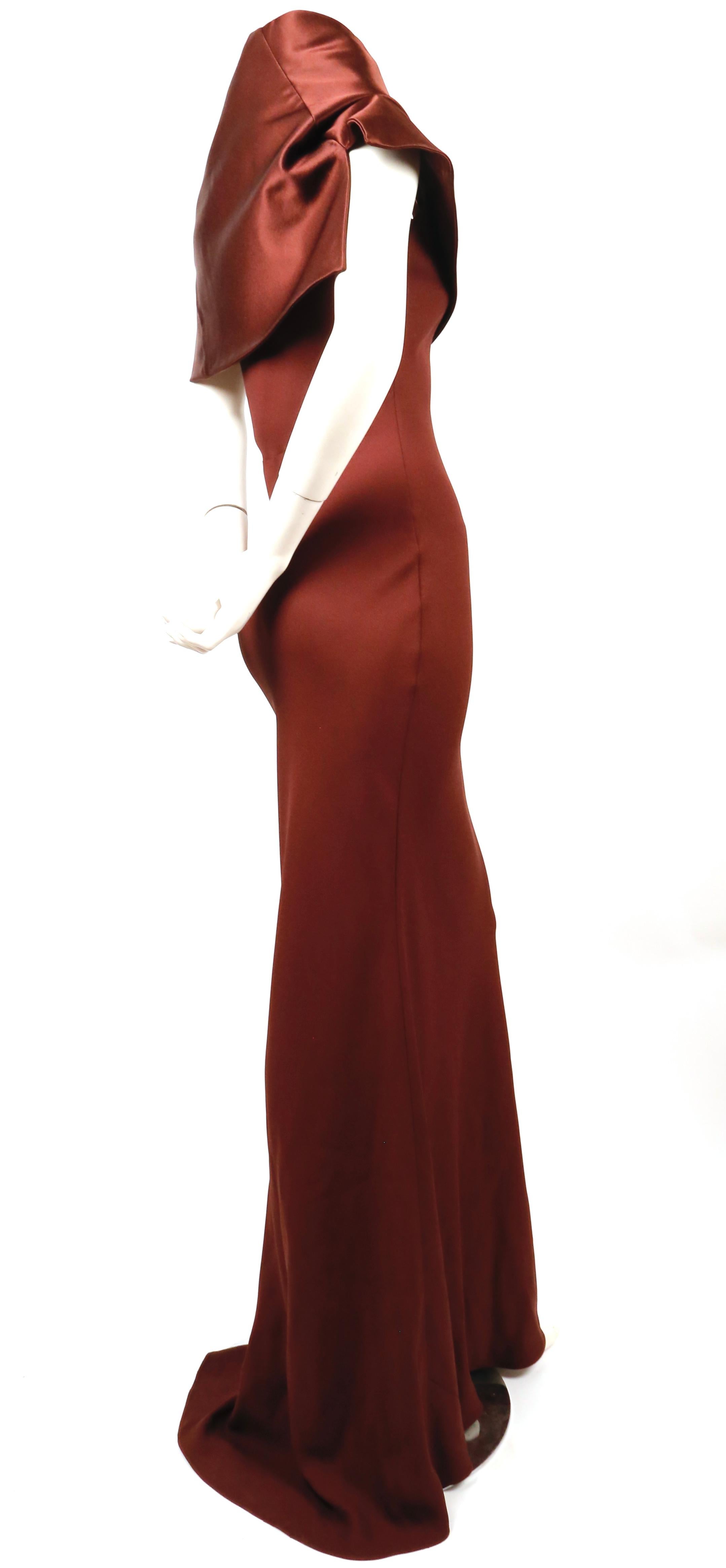 Burgundy satin, bias-cut gown with contrasting raised asymmetrical collar designed by John Galliano dating to fall of 1999. French size 38 which best fits a modern 36. Measurements are very difficult due to the bias cut. Fabric content: 68% acetate