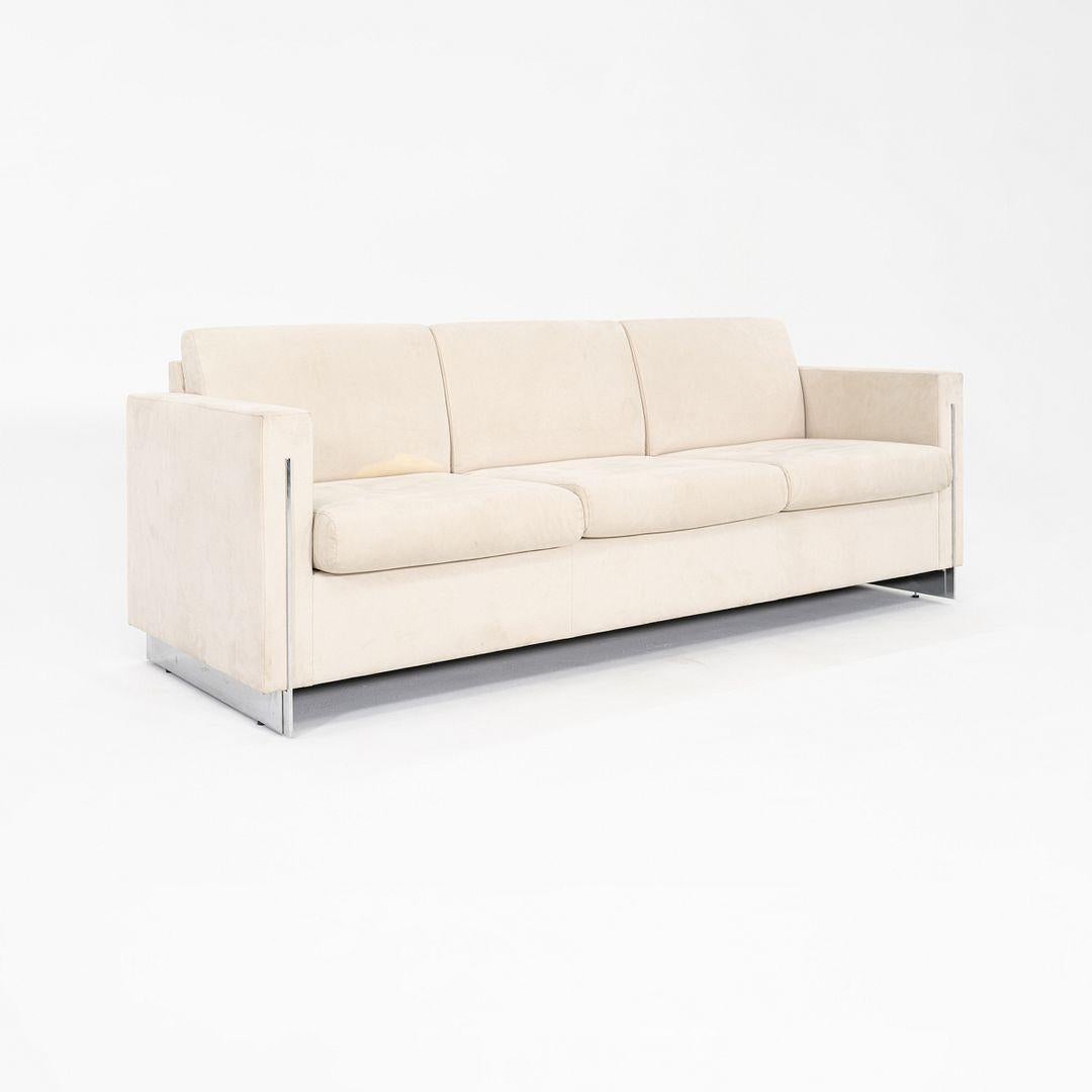 This is a Modern Tuxedo Sofa, designed by John Nelson for Tuohy Seating in the 1990s. The sofa was produced in the USA. The design features white upholstery, and it has an aluminum plinth base. It is a perfect example of how timeless classic