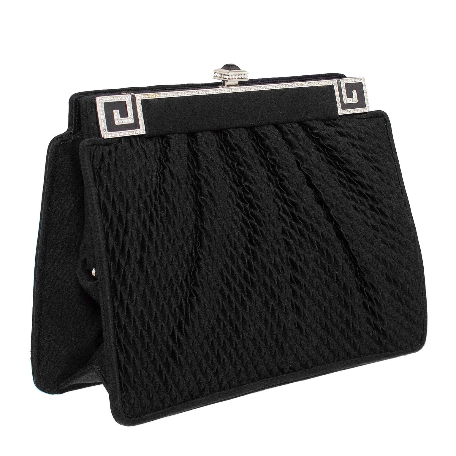 This 1990s Judith Leiber frame style evening bag will take you from a date night dinner to a black tie event. This bag features black textured ripple effect silk that is ruched. The frame is covered in black silk with silver tone metal greek key