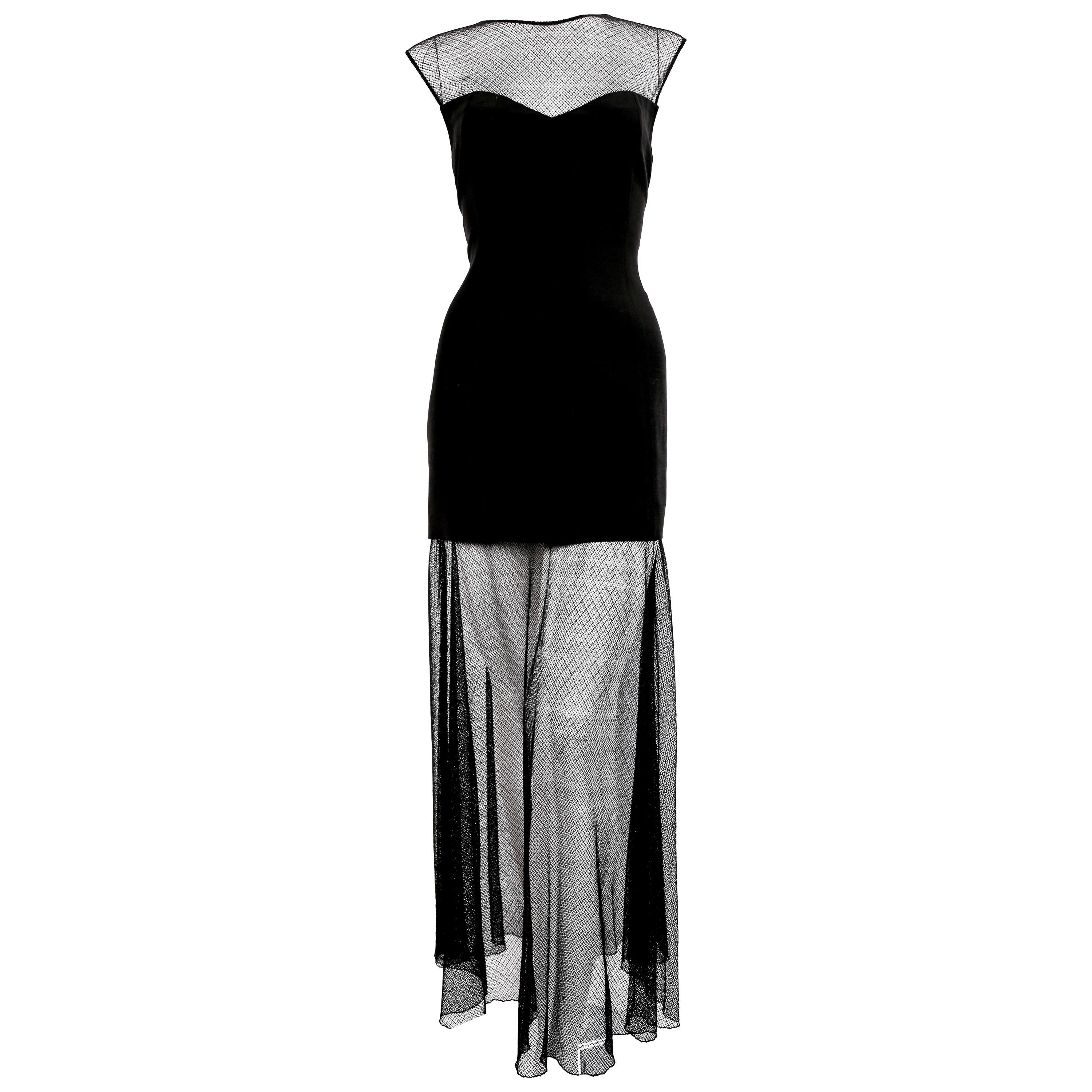 Beautiful black dress with sheer net neckline and skirting from Karl Lagerfeld dating to 1993 as seen on Claudia Schiffer on the fall runway and in a different fabric on Linda Evangalista in a ad campaign. Great dress for summer or layered for fall.