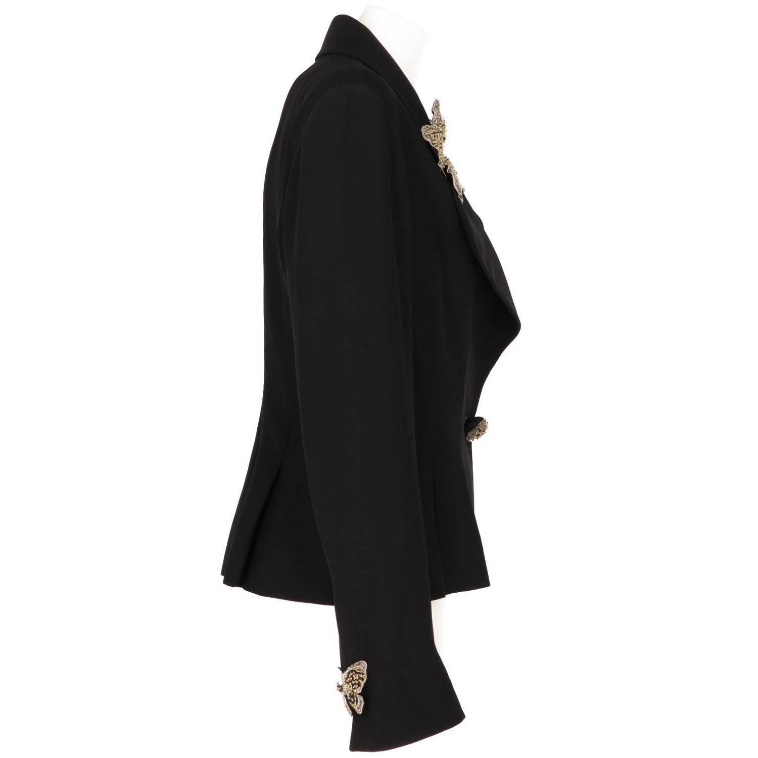 Elegant black blazer by Karl Lagrefeld with scallopped wide revers, front pinces and a pleated bottom. The jacket is embellished with gold and black butterflies jewels applications, made of sequins and beads, on the revers and on the cuffs in a