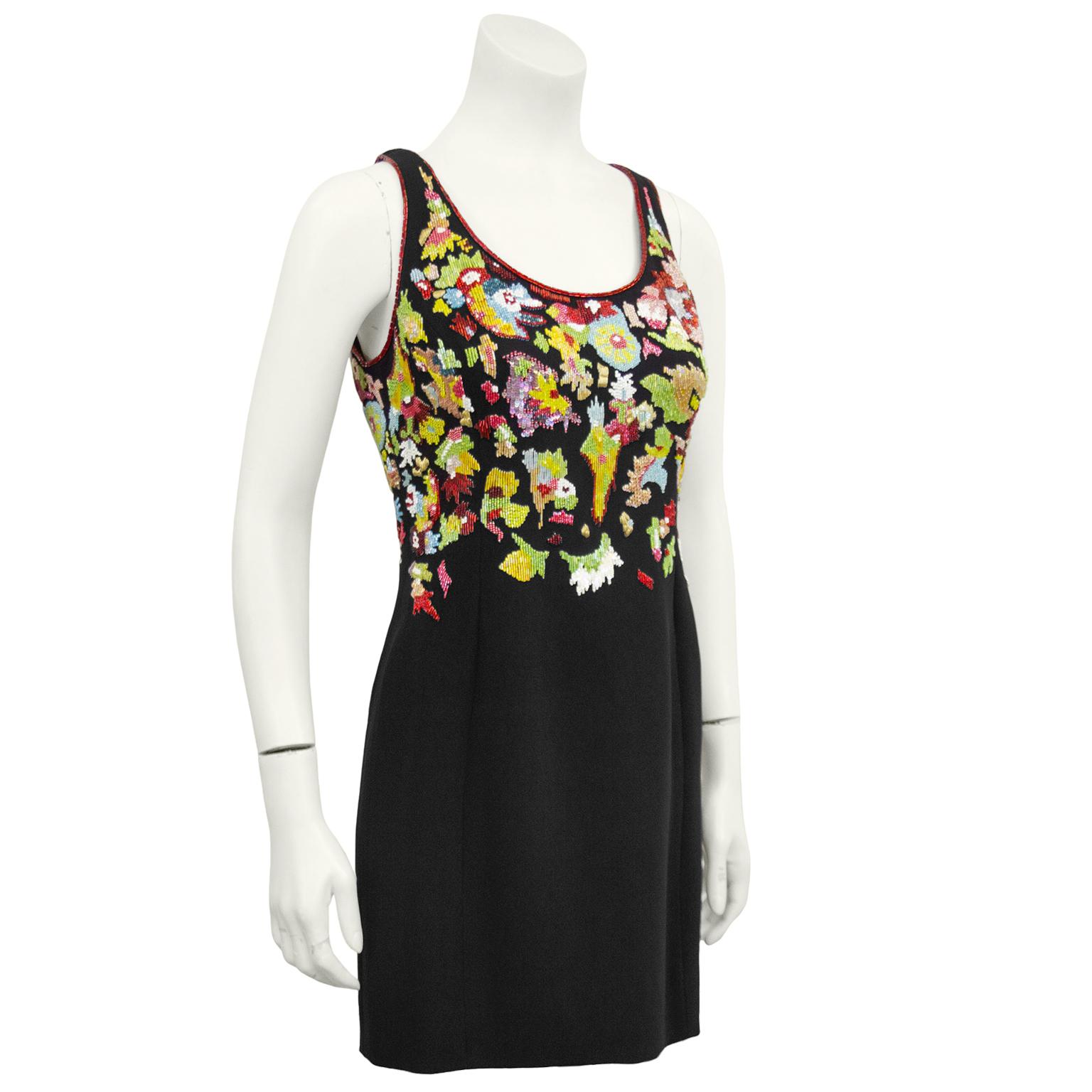 1990's Karl Lagerfeld sleeveless cocktail mini dress with fabulous beading throughout. Necklace and sleeves trimmed in red beading. Deconstructed abstract green, red, yellow, blue and purple hand beaded florals on front and back of bodice. Skirt is