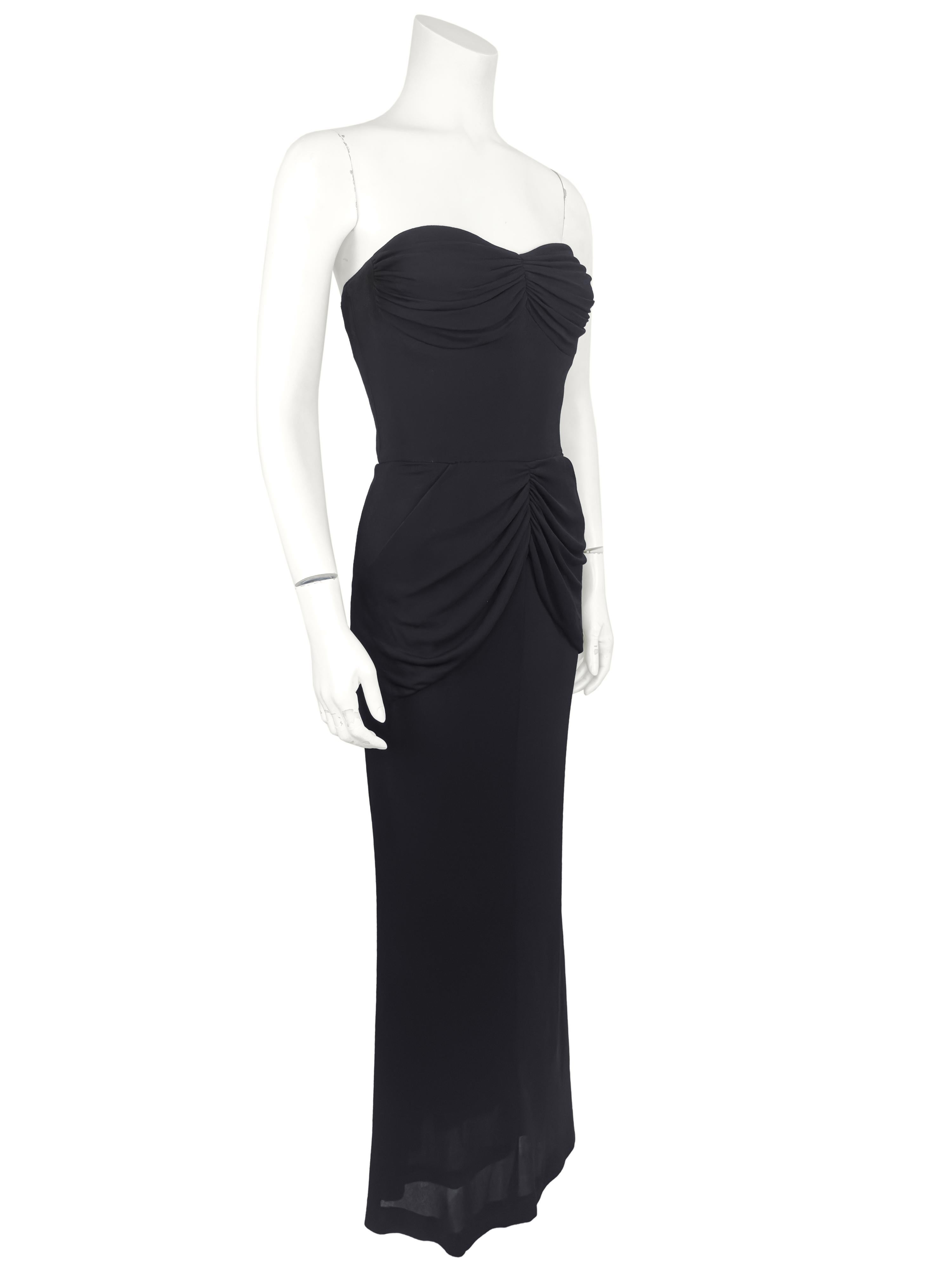 Beautiful black jersey evening gown with draping at the bust and hips. Boning along the sides and back of the body with an interior waistband. Underwire at the bust. The draping long the hips conceals two hidden hip pockets. The dress is structured