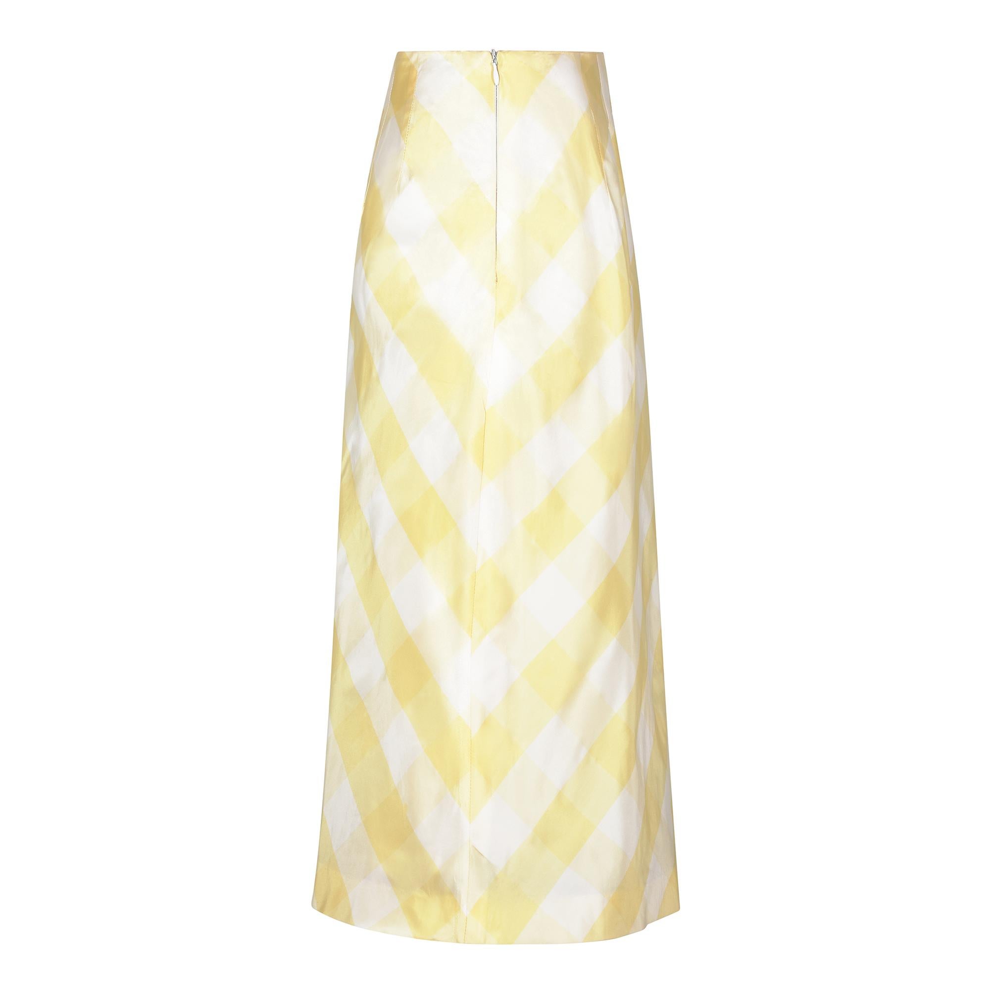 This 1990s Chloe silk taffeta yellow gingham print skirt was very likely made by Karl Lagerfeld who worked extensively with Chloe throughout the 1960s and 1970s and again in the 1990s. The skirt is a large square check or gingham pattern in lemon